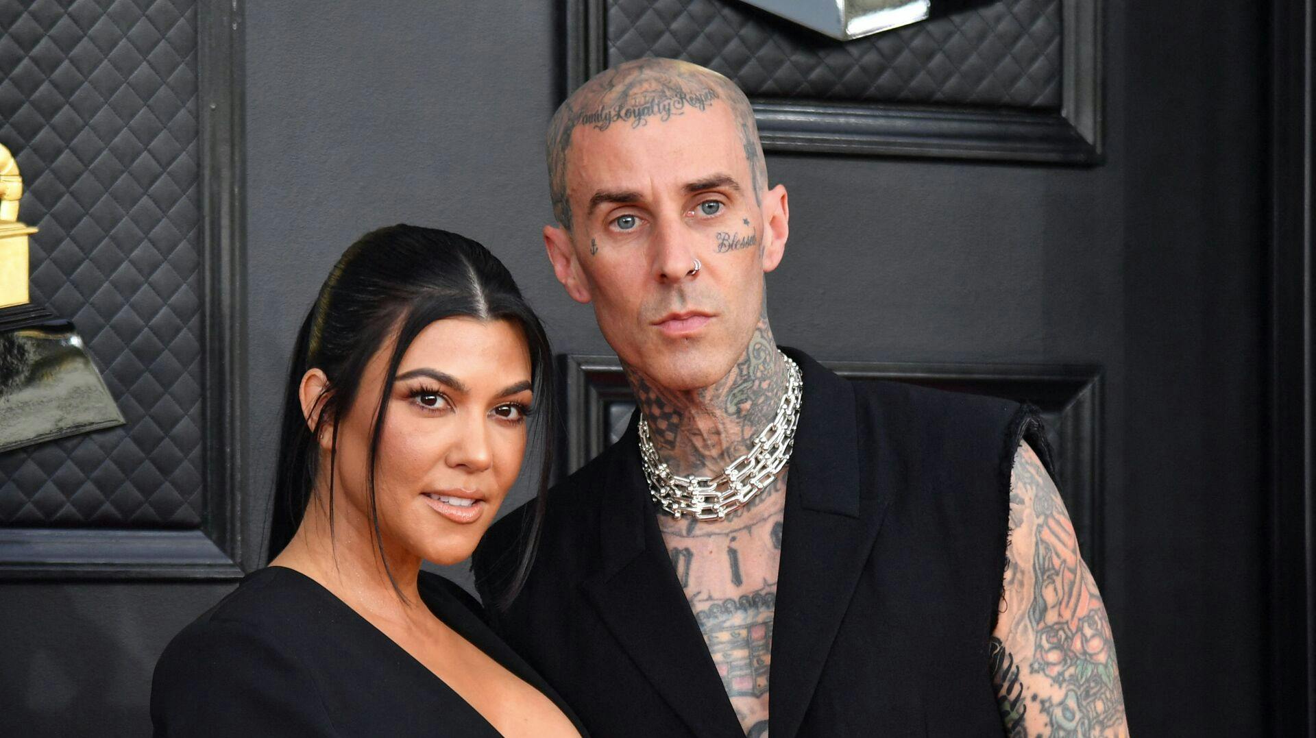 Kourtney Kardashian and musician Travis Barker arrive for the 64th Annual Grammy Awards at the MGM Grand Garden Arena in Las Vegas on April 3, 2022. (Photo by ANGELA WEISS / AFP)