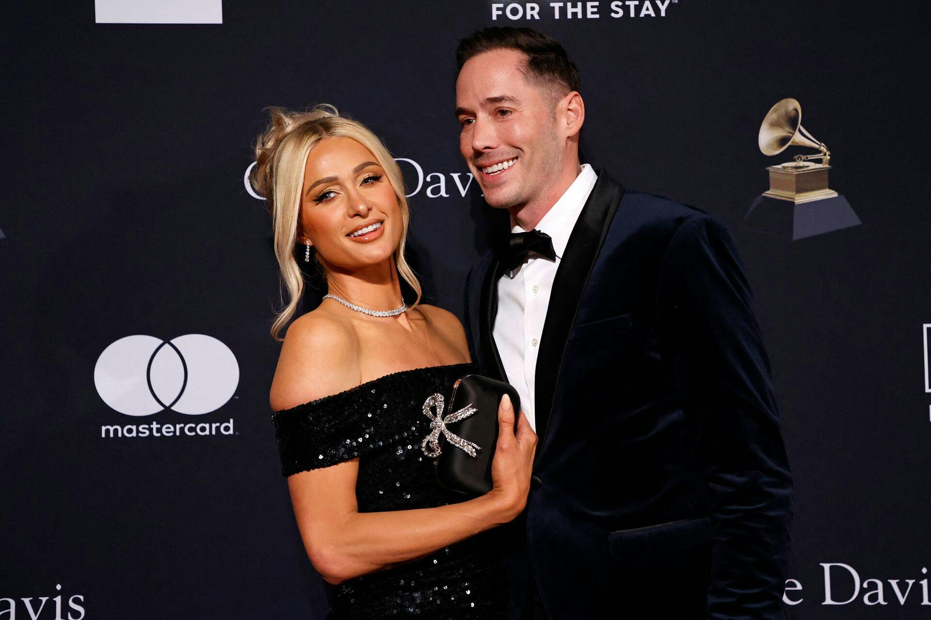 US socialite Paris Hilton (L) and husband US author Carter Reum arrive for the Recording Academy and Clive Davis pre-Grammy gala at the Beverly Hilton hotel in Beverly Hills, California on February 4, 2023. (Photo by Michael TRAN / AFP)