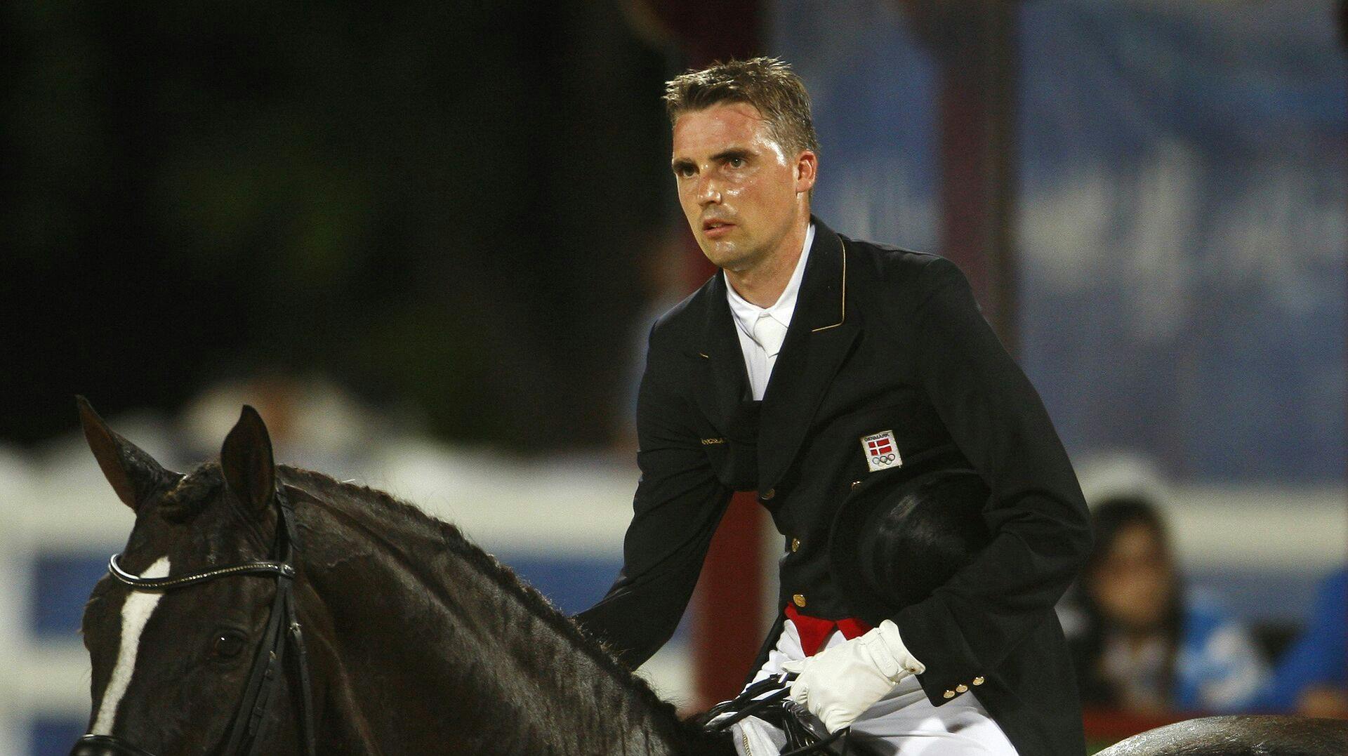 Andreas Helgstrand of Denmark riding Don Schufro reacts after competing in the equestrian dressage individual grand prix special competition at the Beijing 2008 Olympic Games in Hong Kong August 16, 2008. REUTERS/Bobby Yip (CHINA)