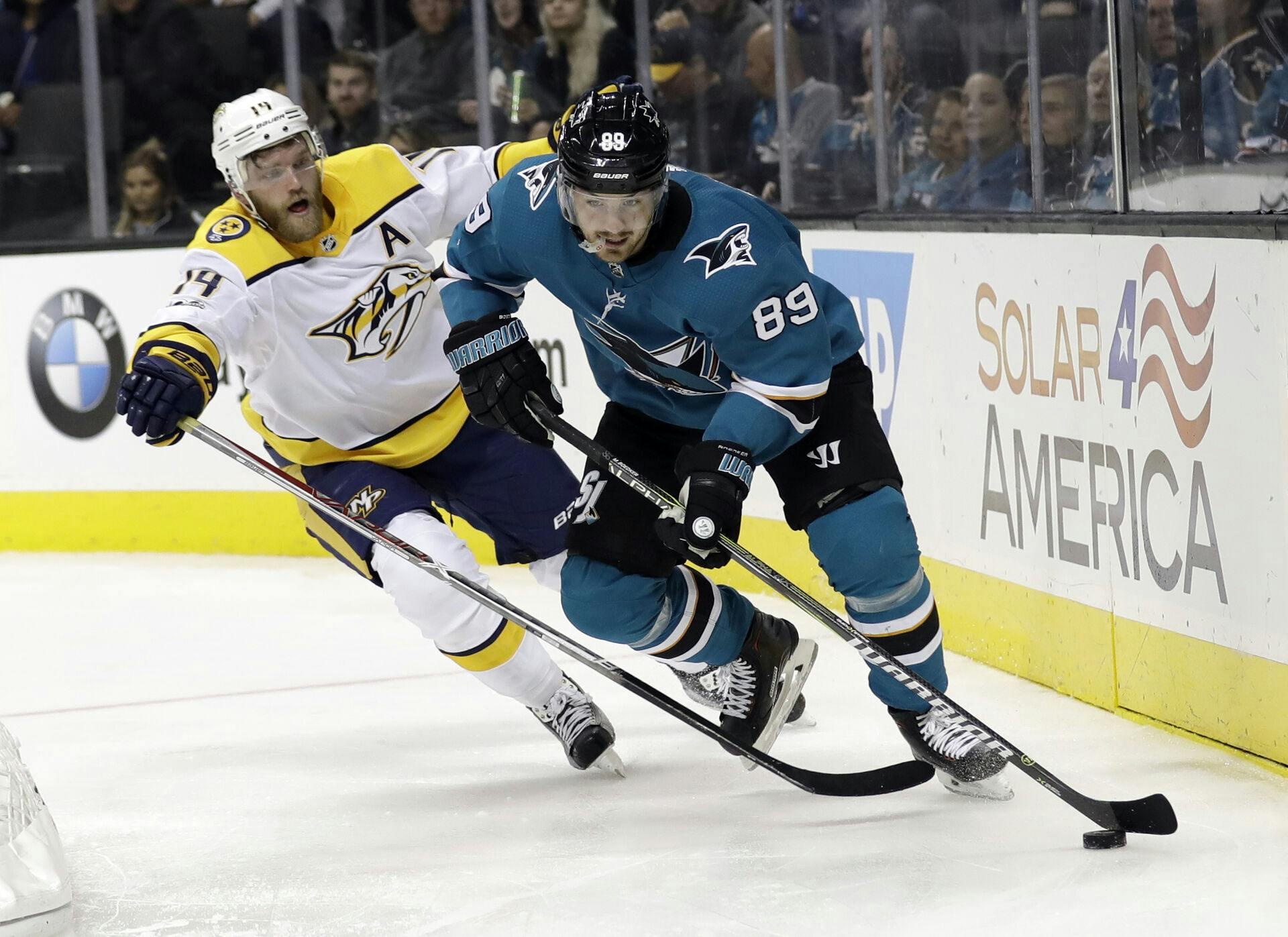 San Jose Sharks' Mikkel Bødker (89) is defended by Nashville Predators' Mattias Ekholm during the second period of an NHL hockey game Wednesday, Nov. 1, 2017, in San Jose, Calif. (AP Photo/Marcio Jose Sanchez)