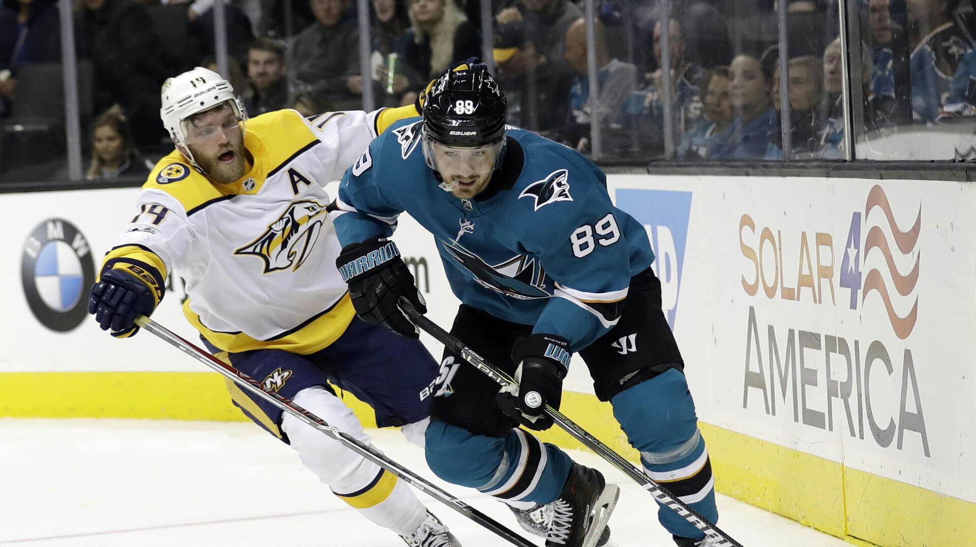 San Jose Sharks' Mikkel Bødker (89) is defended by Nashville Predators' Mattias Ekholm during the second period of an NHL hockey game Wednesday, Nov. 1, 2017, in San Jose, Calif. (AP Photo/Marcio Jose Sanchez)