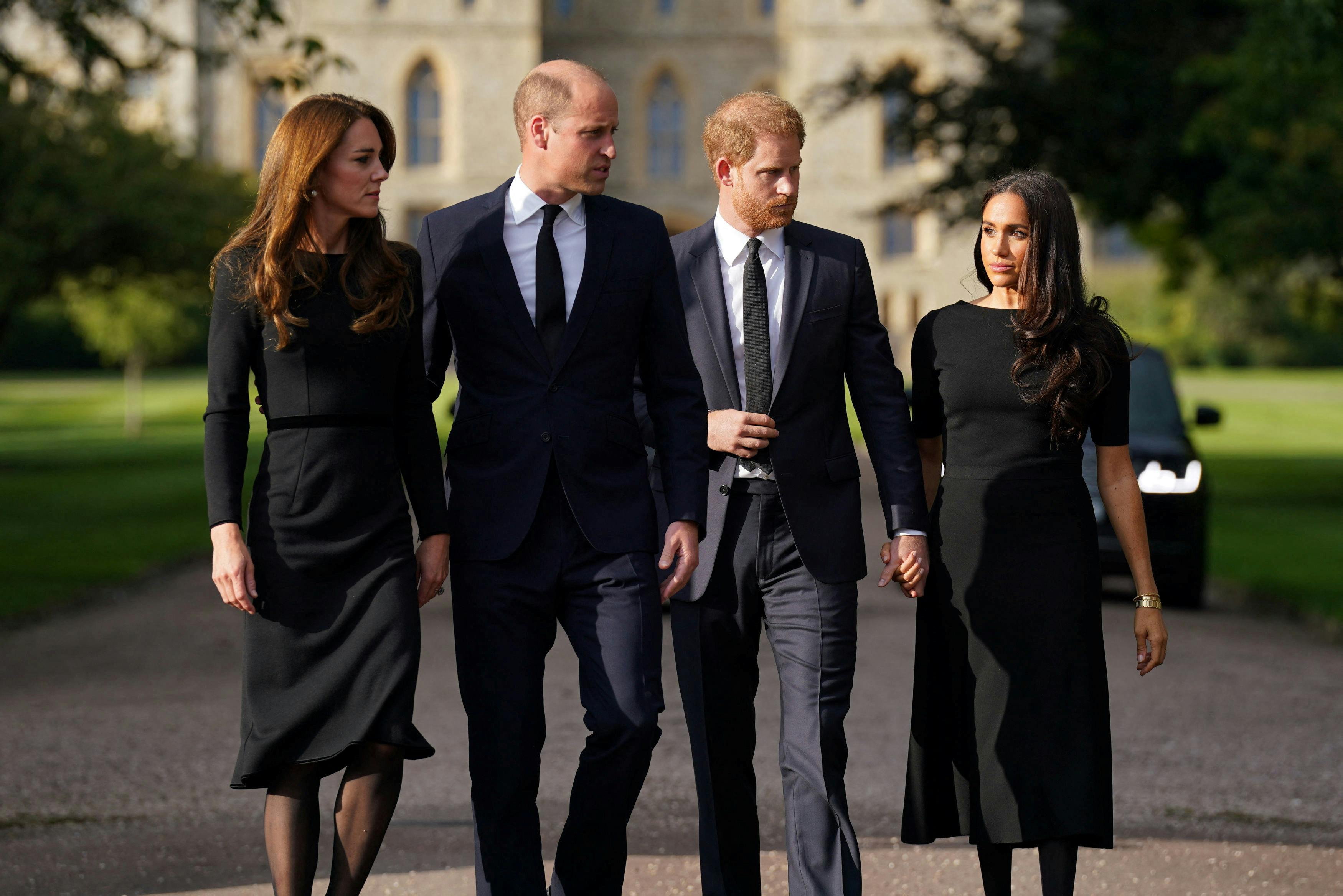 Britain's William, Prince of Wales, Catherine, Princess of Wales, Britain's Prince Harry and Meghan, the Duchess of Sussex, walk to meet members of the public at Windsor Castle, following the passing of Britain's Queen Elizabeth, in Windsor, Britain, September 10, 2022. Kirsty O'Connor/PA Wire/Pool via REUTERS