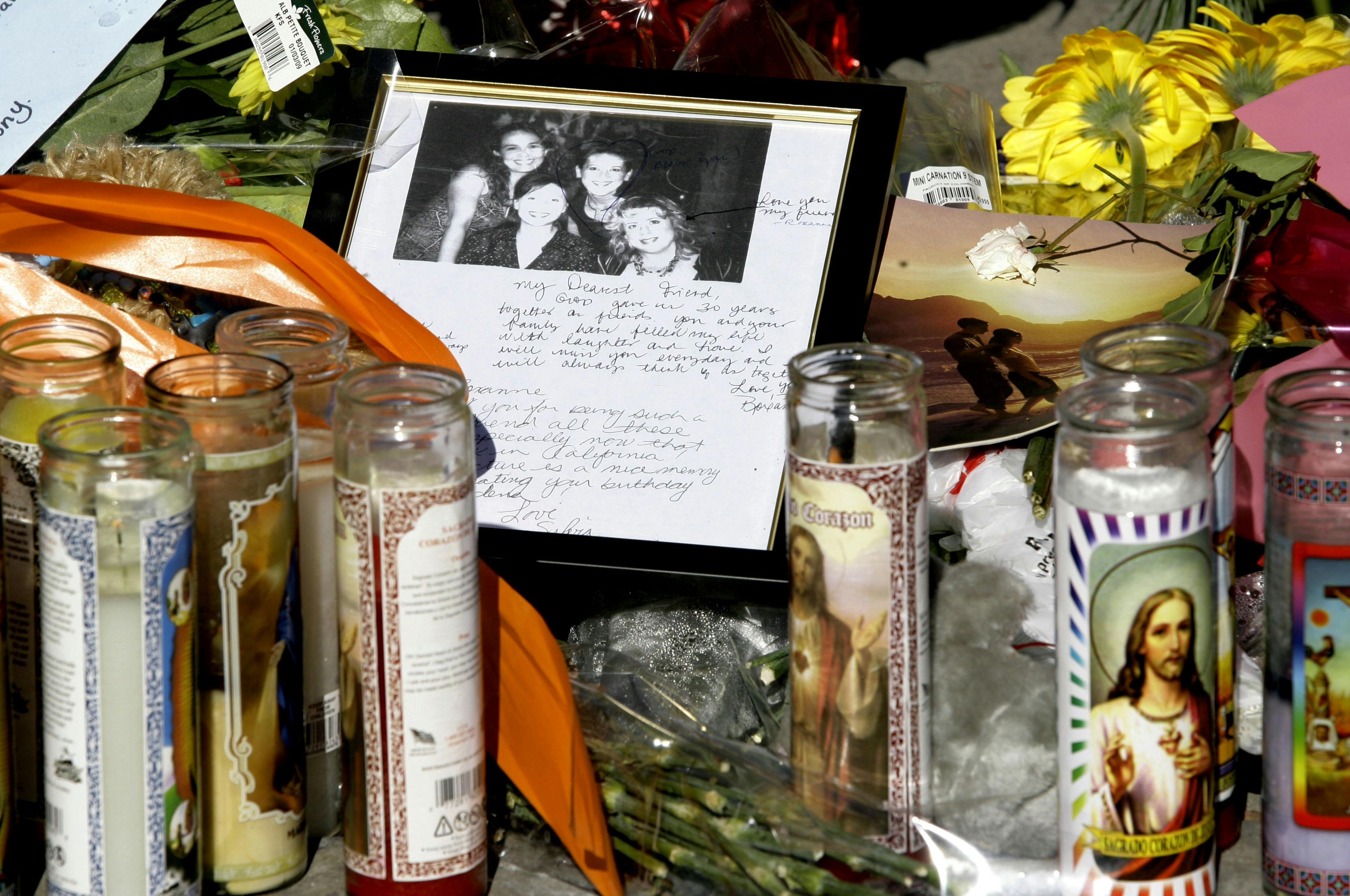 A photo left at an impromptu memorial set up near the ruins of the Ortega family home is shown in Covina, Calif. on Monday Dec. 29, 2008. Bruce Pardo, dressed as Santa, shot indiscriminately at partygoers and destroyed his former in-laws' house with a homemade blowtorch, ultimately leaving nine people dead before killing himself.(AP Photo/Nick Ut)