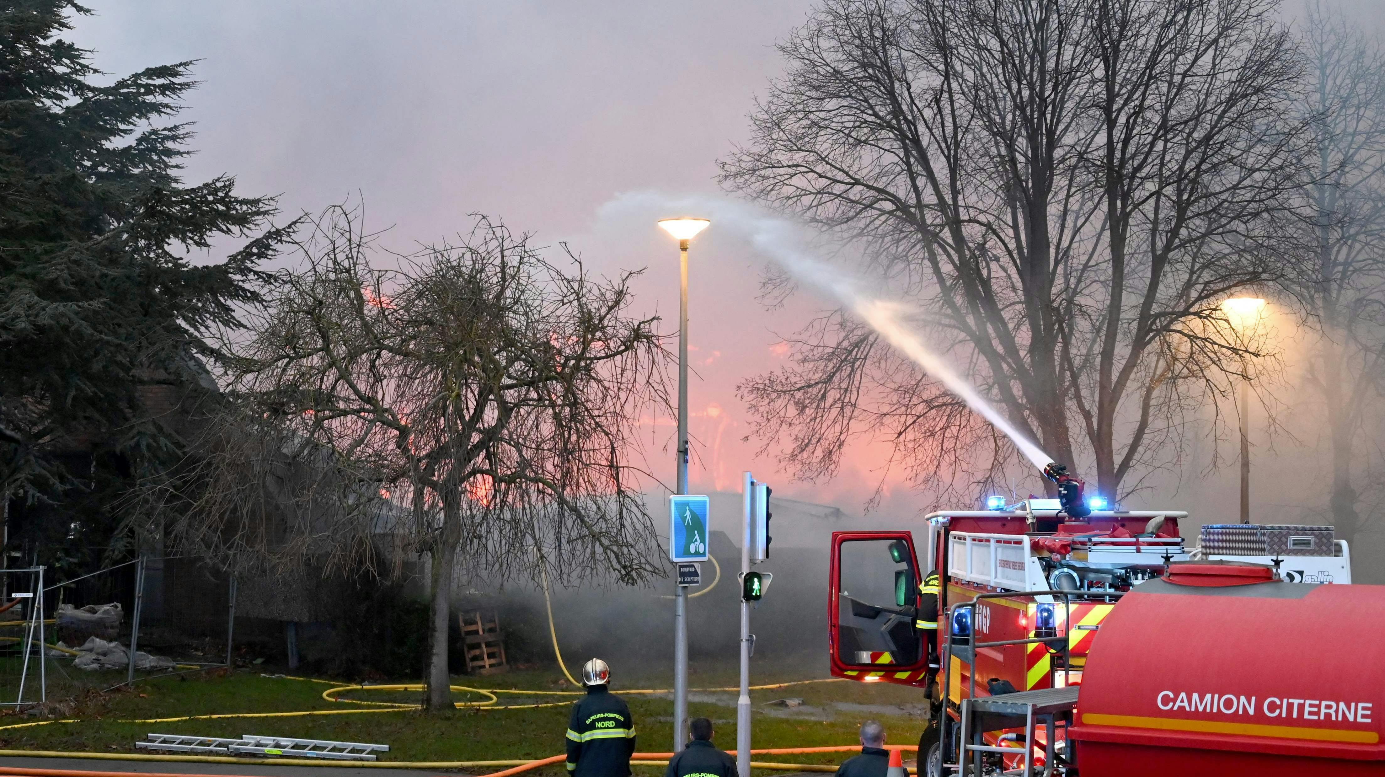 Firefighters spray water o