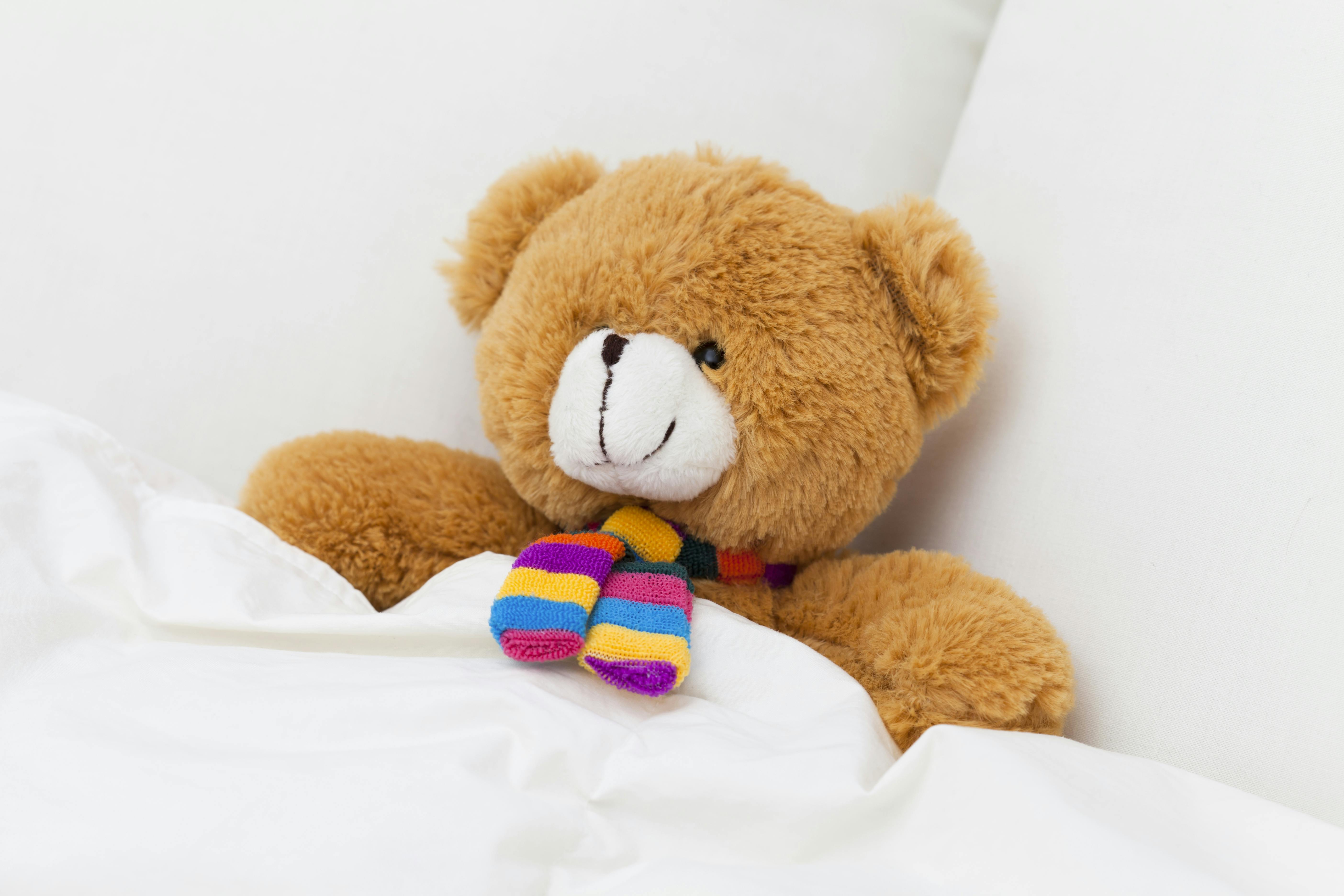 Teddy bear sleeping in a bed