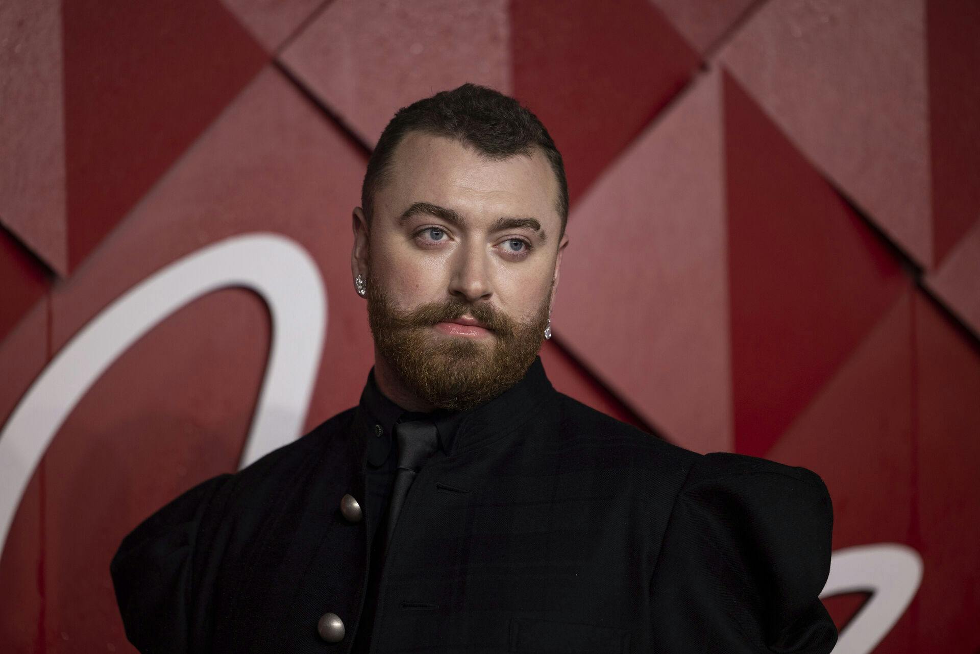 Sam Smith poses for photographers upon arrival at the British Fashion Awards on Monday, Dec. 4, 2023 in London. (Vianney Le Caer/Invision/AP)