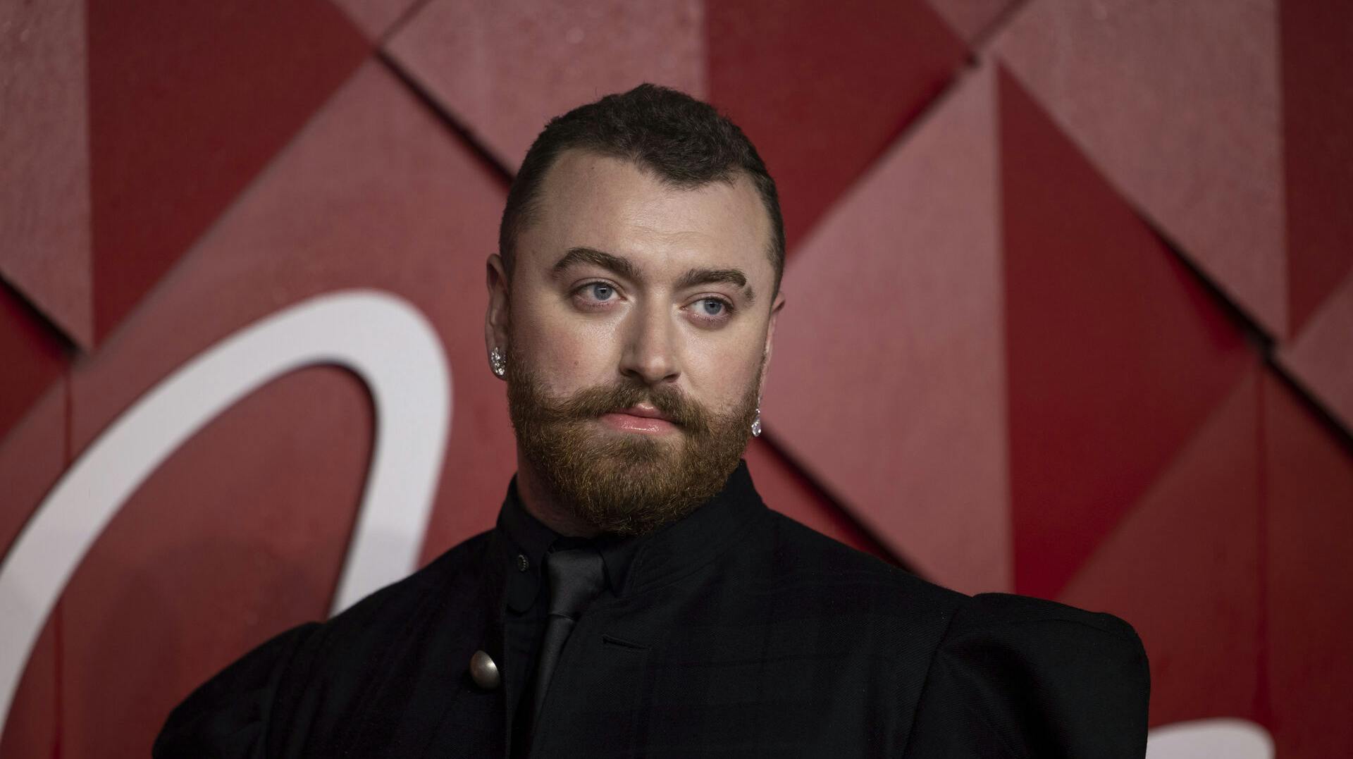 Sam Smith poses for photographers upon arrival at the British Fashion Awards on Monday, Dec. 4, 2023 in London. (Vianney Le Caer/Invision/AP)