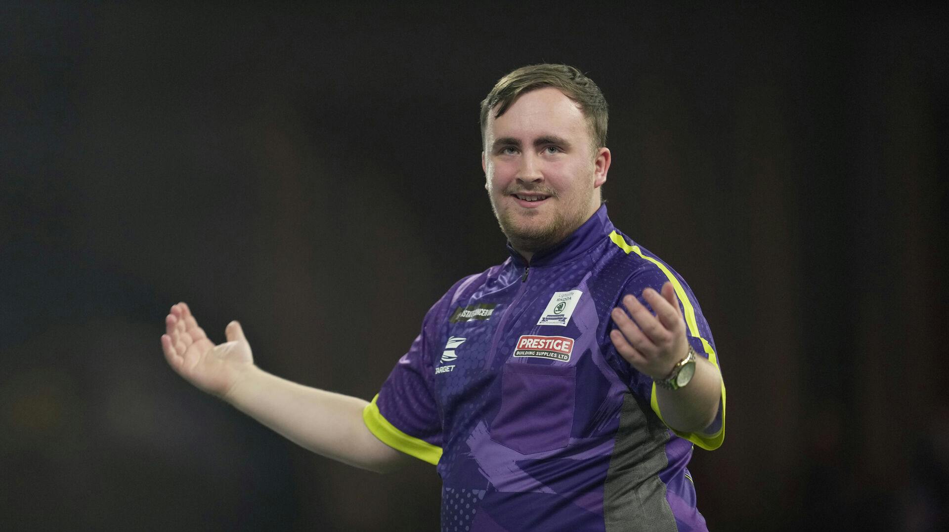 Luke Littler of England reacts during the semifinal match against Scott Williams of England at the World Darts Championship, in London, Tuesday, Jan. 2, 2024. (AP Photo/Kin Cheung)