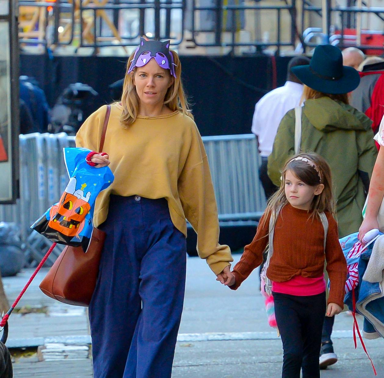 Sienna Miller and daughter Marlowe walk to the Halloween parade with go in New York. **SPECIAL INSTRUCTIONS*** Please pixelate children's faces before publication.**. 31 Oct 2018 Pictured: Sienna Miller and Marlowe Miller. Photo credit: PC / MEGA TheMegaAgency.com +1 888 505 6342 (Mega Agency TagID: MEGA300735_001.jpg) [Photo via Mega Agency]