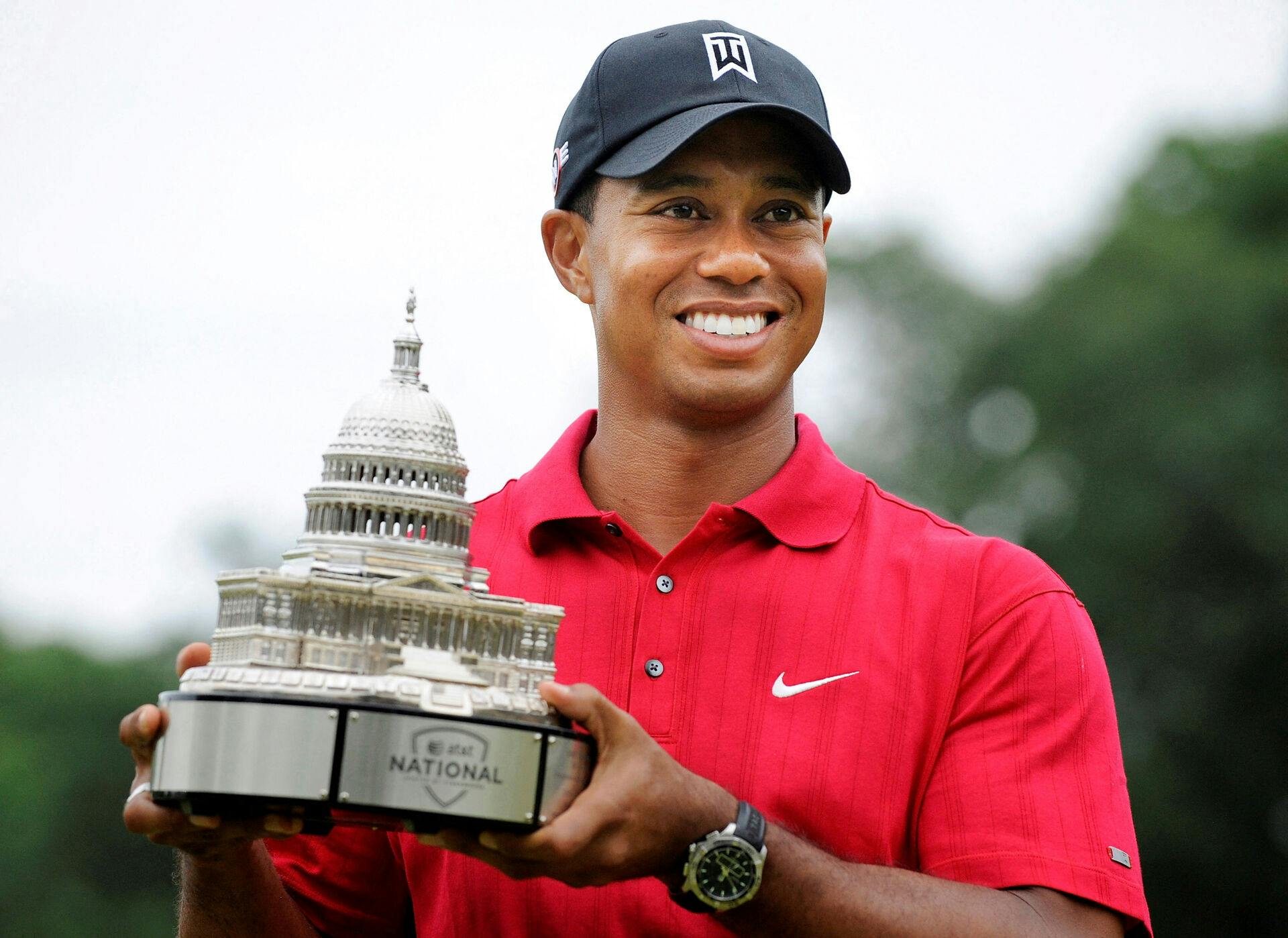 FILE PHOTO: Tiger Woods holds the trophy after winning in the final round of the AT&T National PGA golf tournament at Congressional Country Club in Bethesda, Maryland, July 5, 2009. REUTERS/Jonathan Ernst/File Photo