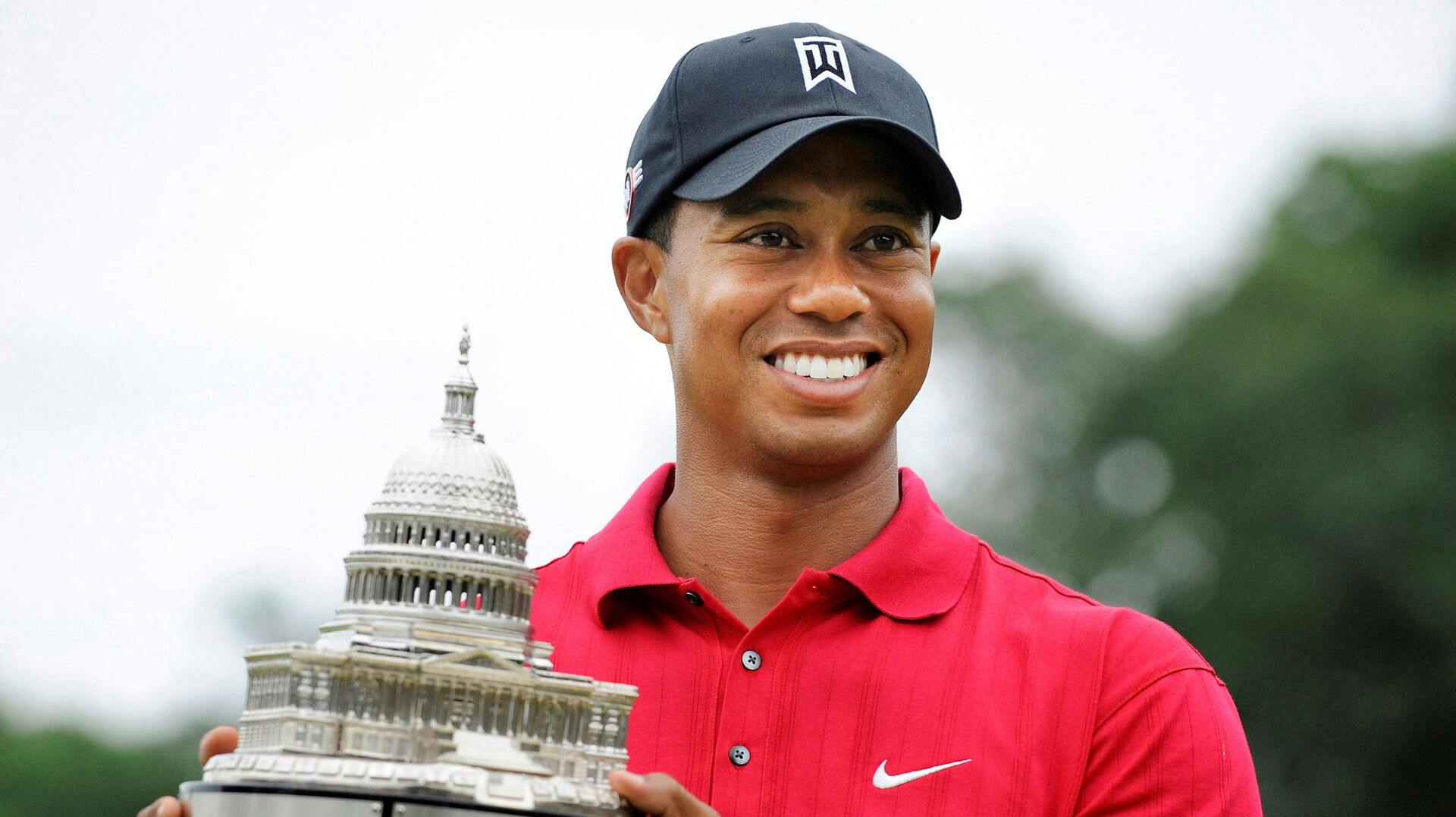 FILE PHOTO: Tiger Woods holds the trophy after winning in the final round of the AT&T National PGA golf tournament at Congressional Country Club in Bethesda, Maryland, July 5, 2009. REUTERS/Jonathan Ernst/File Photo