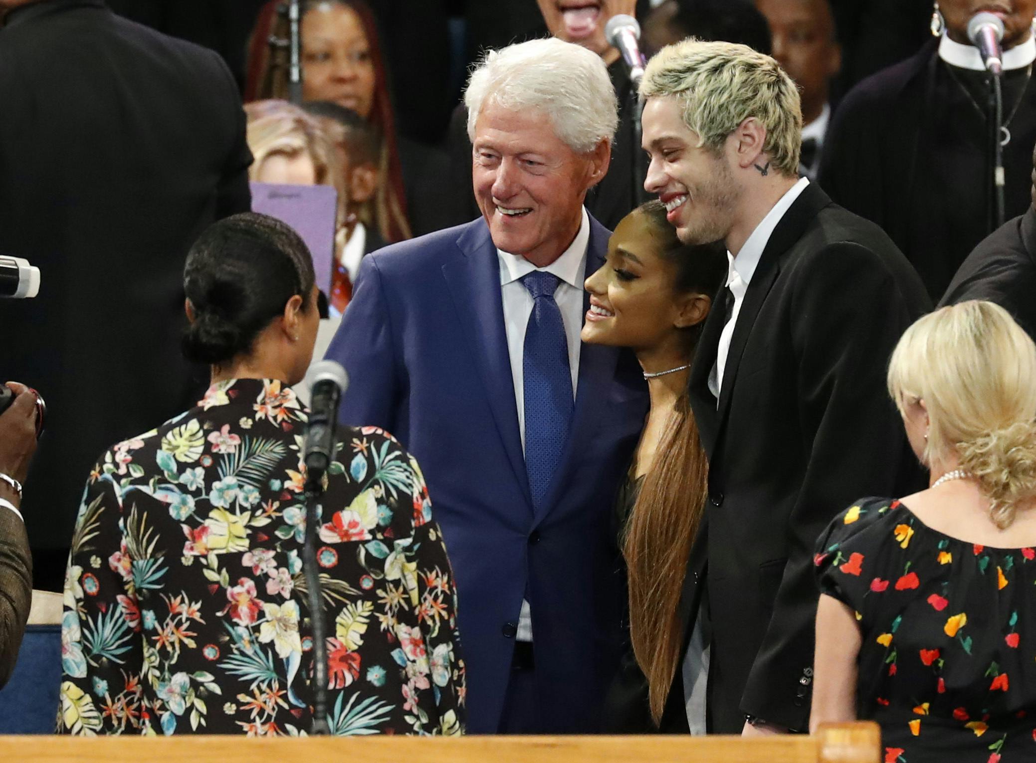 Former President Bill Clinton poses for a photo with Ariana Grande, center, and Pete Davidson, right, during the funeral service for Aretha Franklin at Greater Grace Temple, Friday, Aug. 31, 2018, in Detroit. Franklin died Aug. 16, 2018 of pancreatic cancer at the age of 76. (AP Photo/Paul Sancya)