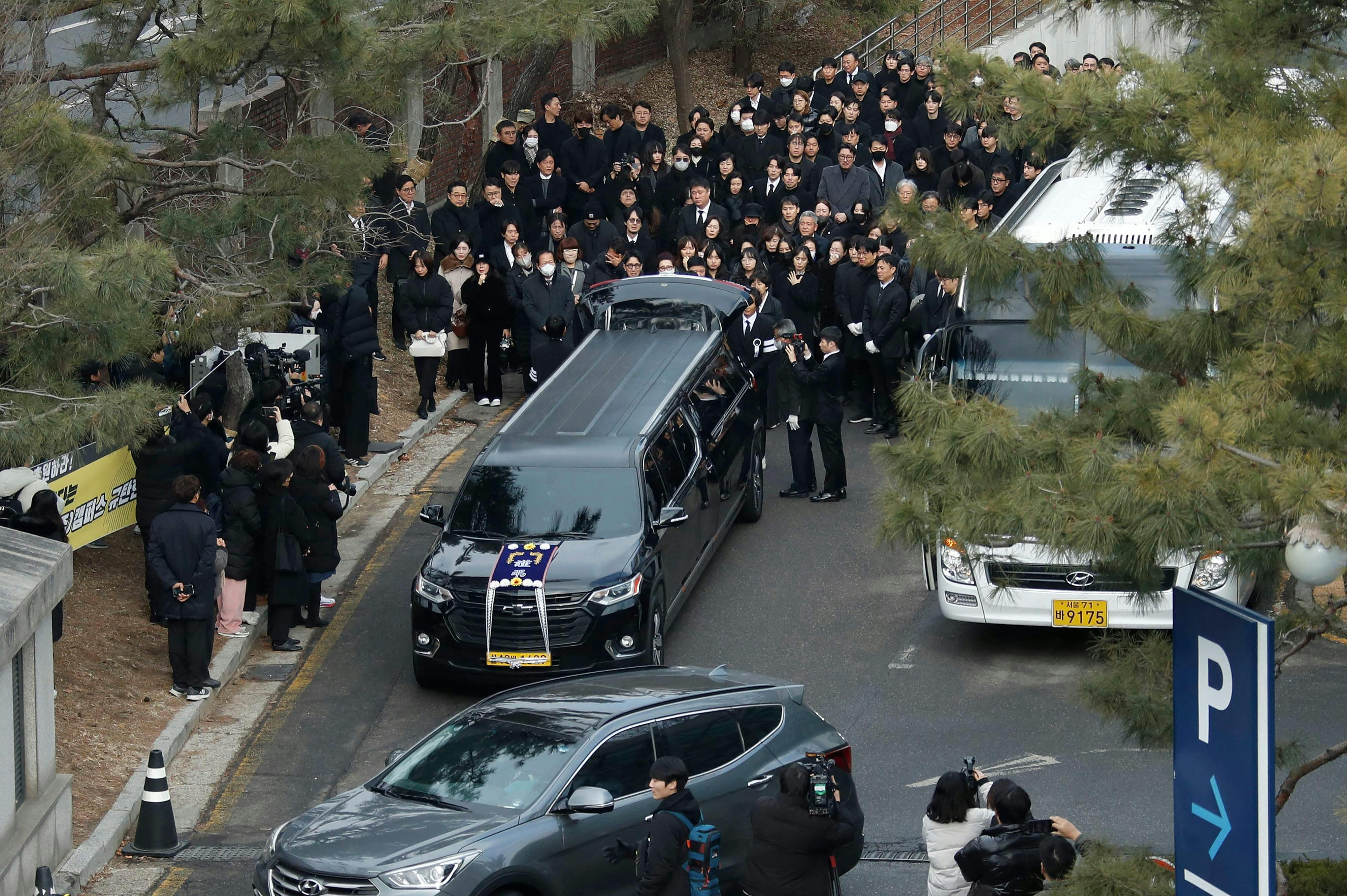 The hearse carrying the casket of late South Korean actor Lee Sun-kyun leaves a funeral hall after his funeral ceremony at the Seoul National University Hospital in Seoul on December 29, 2023. The late South Korean actor Lee Sun-kyun's body was transported from the funeral home to a crematorium in a private ceremony on December 29, with his death raising questions about alleged harsh police practices and media sensationalism. (Photo by KOREA POOL / AFP)
