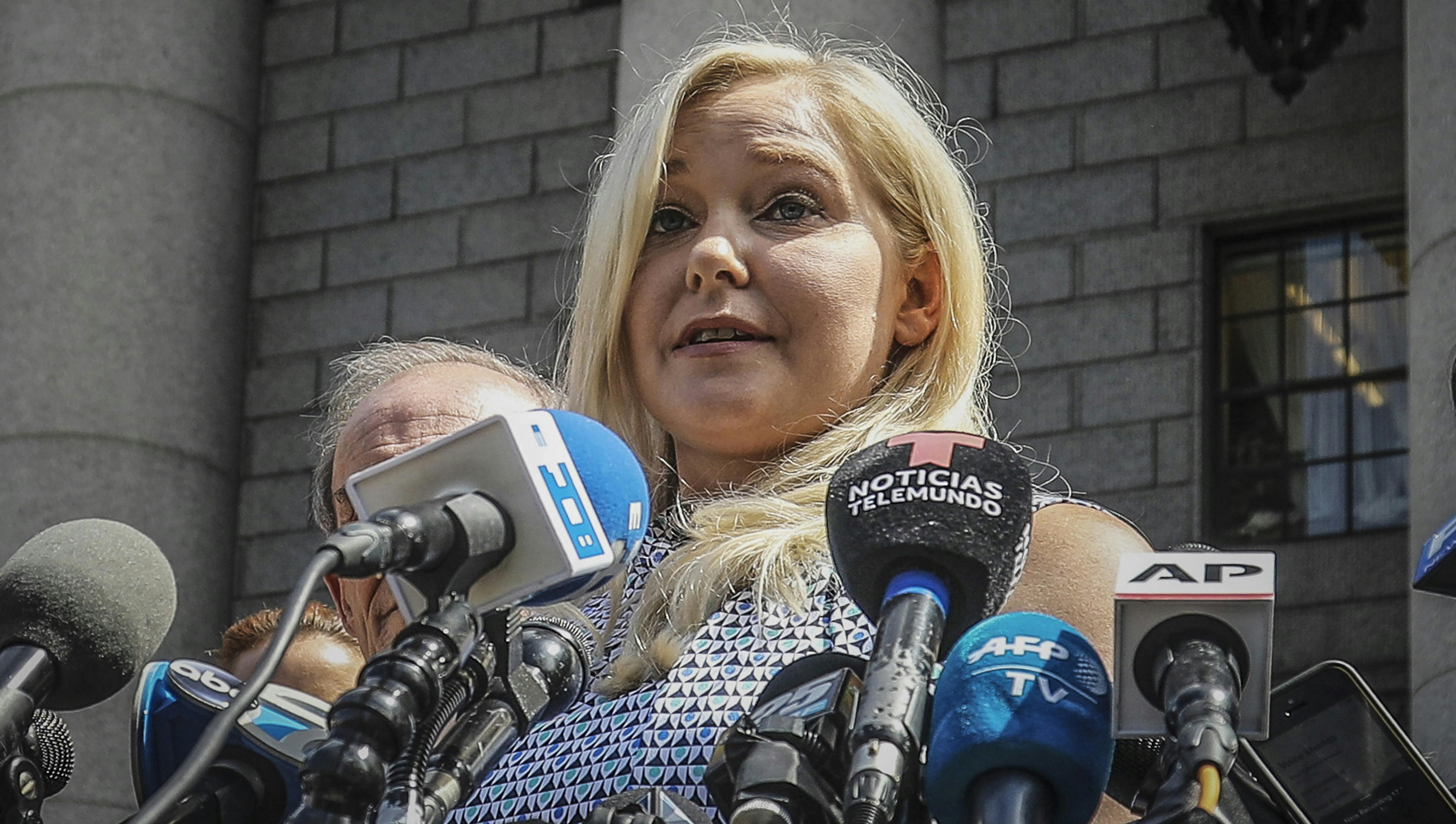 FILE - Virginia Roberts Giuffre holds a news conference outside a Manhattan court following the jailhouse death of Jeffrey Epstein, Aug. 27, 2019, in New York. Lawyers for Prince Andrew and Giuffre, who accused him of sexually abusing her when she was 17, formally asked a judge Tuesday to dismiss her lawsuit.(AP Photo/Bebeto Matthews, File)