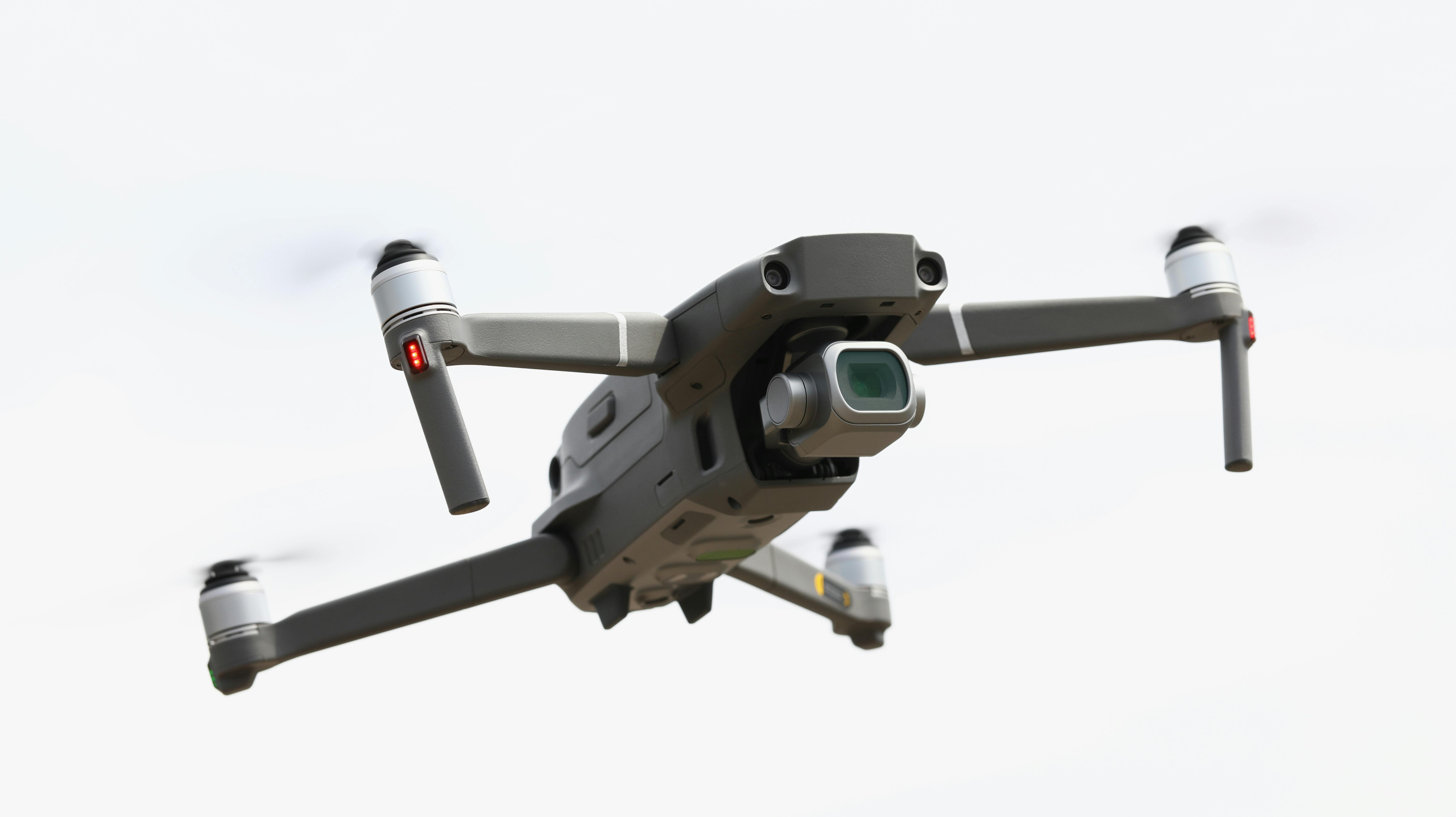 Silvery drone flies in sky. Drone aerial photography concept