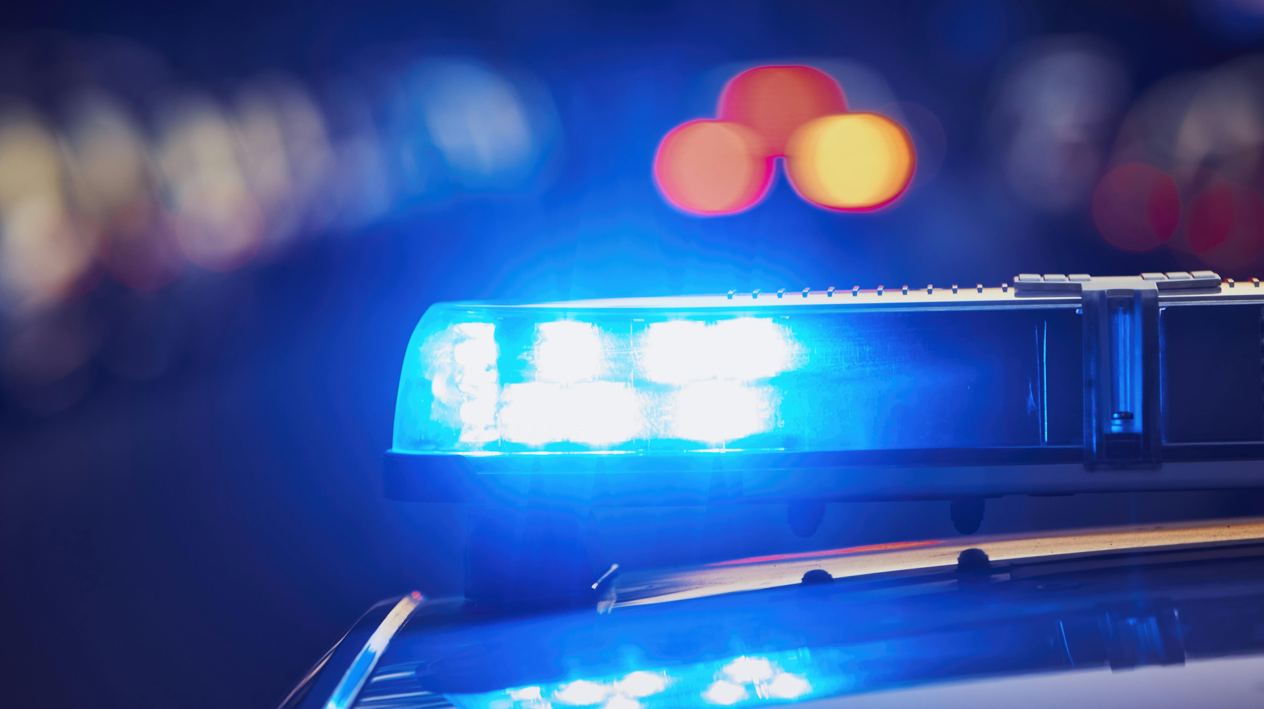 Siren light on roof of police car at street. Themes crime, emergency and help.