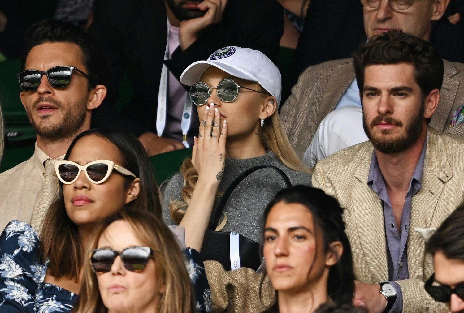Tennis - Wimbledon - All England Lawn Tennis and Croquet Club, London, Britain - July 16, 2023 Actor Jonathan Bailey, singer Ariana Grande and actor Andrew Garfield in the stands during the men's singles final REUTERS/Dylan Martinez
