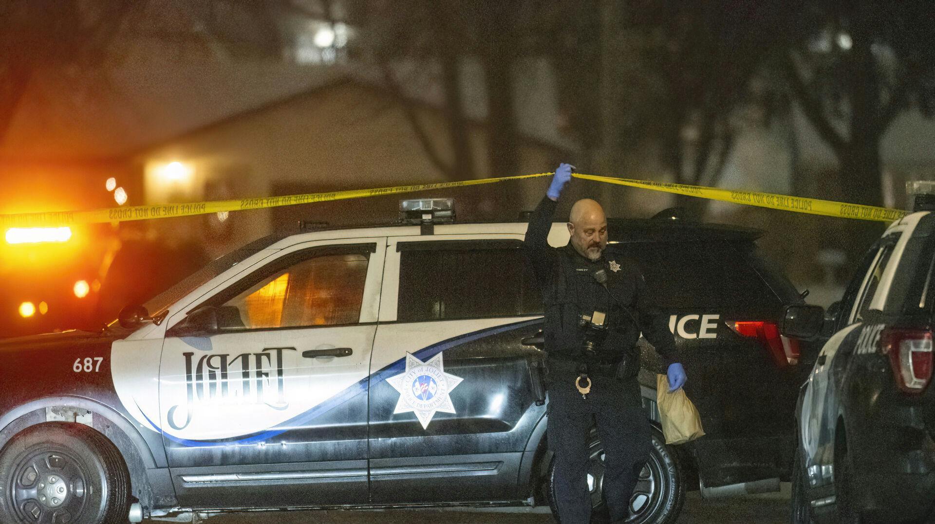 Police work a scene, Monday, Jan. 22, 2024, in Joliet, Ill., after multiple people were shot and killed over two days at three locations in the Chicago suburbs. (Tyler Pasciak LaRiviere/Chicago Sun-Times via AP)