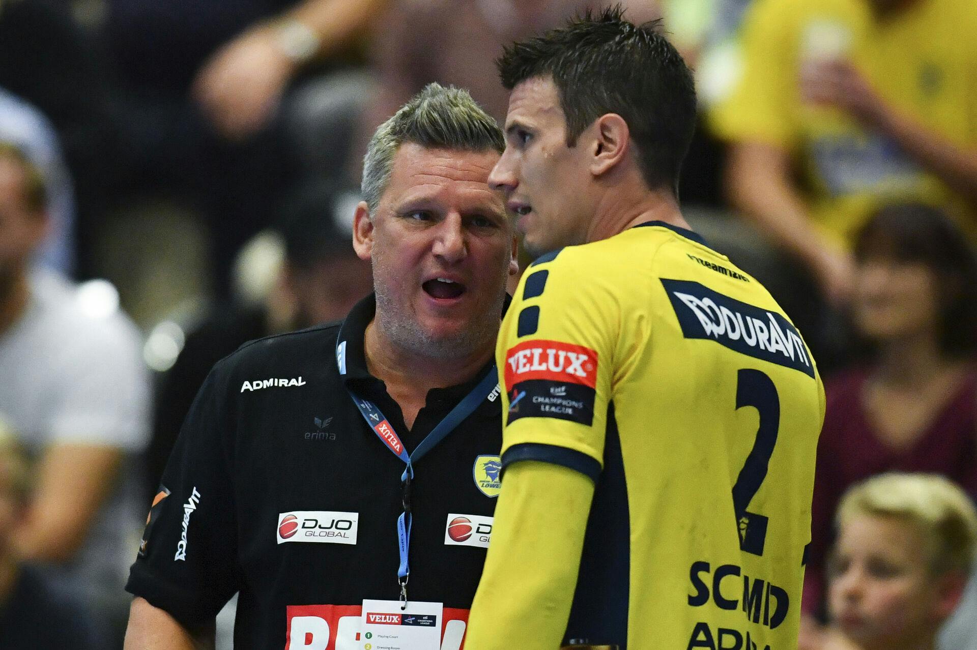 The coach Nikolaj Jacobsen (L) of Rhein-Neckar Loewen speaks to Andy Schmid during the handball Champions League group stages, group A, match between Rhein-Neckar Loewen vs Wisla Plock in Sankt Leon-Rot, 'Germany, 20 September 2017. Photo by: Uwe Anspach/picture-alliance/dpa/AP Images