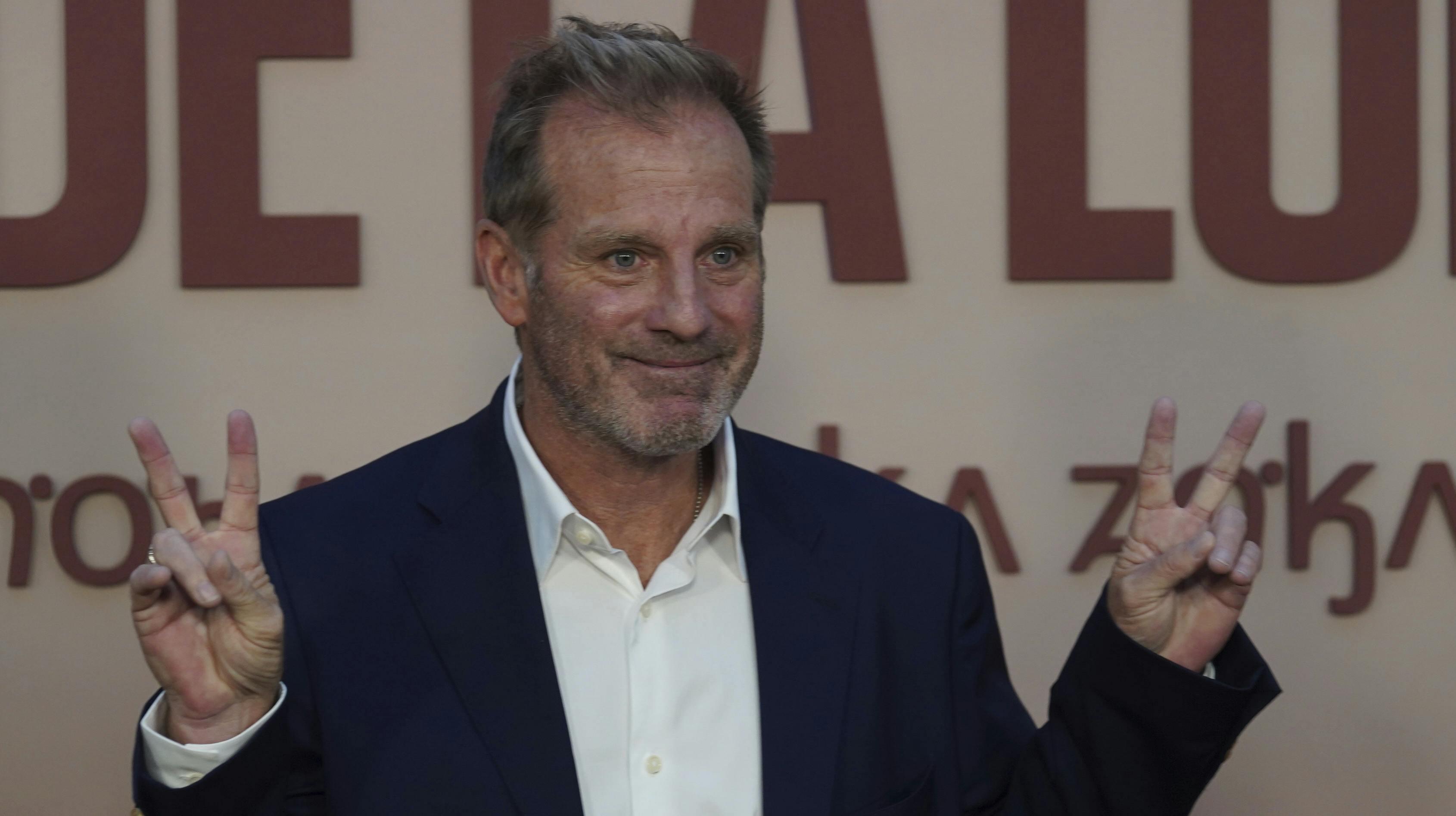 Producer Bradley Thomas gestures for the photographers upon his arrival for the premiere of the film Killers of the Flower Moon, in Mexico City, Wednesday, Oct. 11, 2023. (AP Photo/Marco Ugarte)