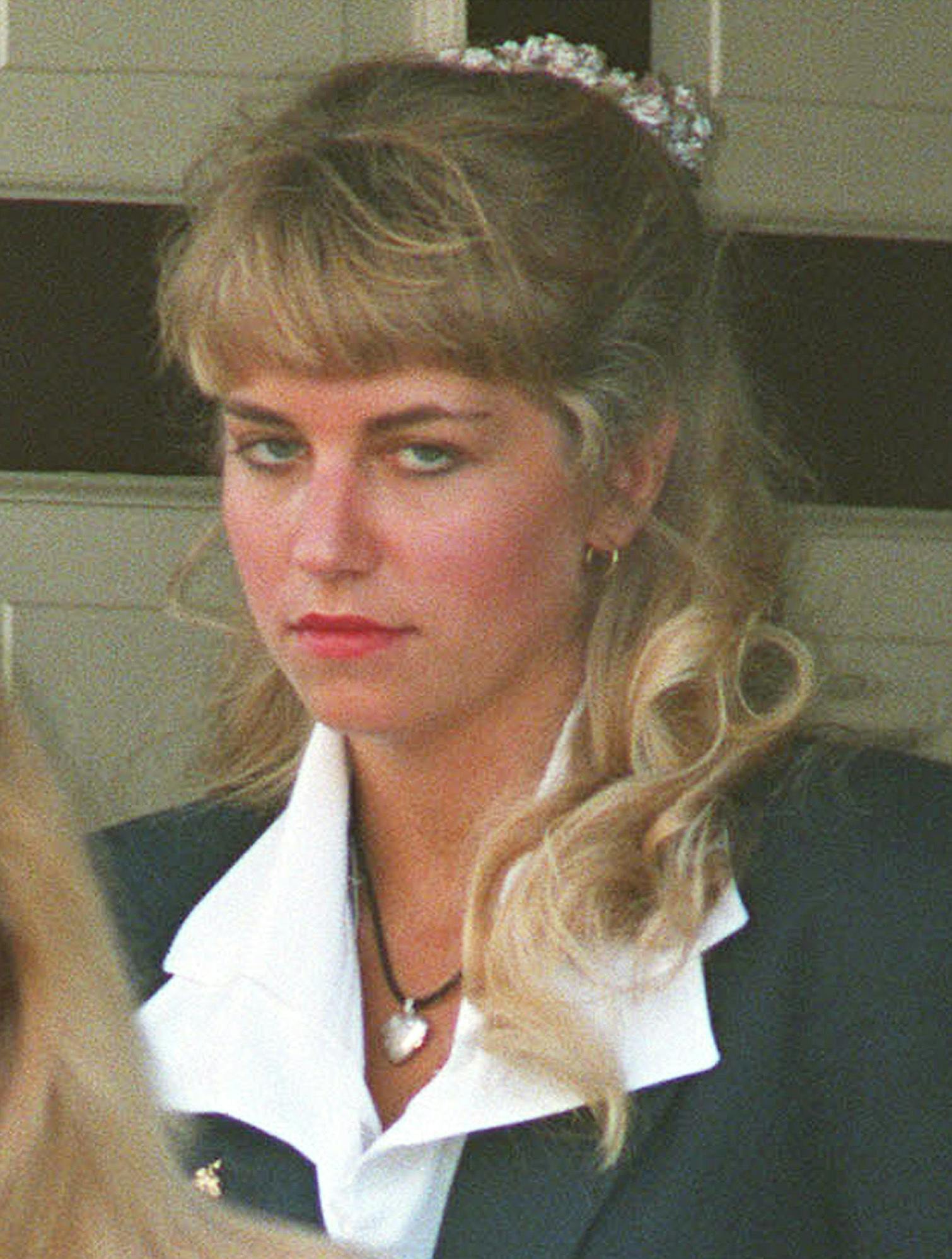 ** FILE ** Karla Homolka leaves her family home in St. Catharines, Ont., in this July 6, 1993 file photo. Homolka, the most reviled woman in Canada is set to walk out of prison Monday, July 4, 2005, after serving 12 years for the rapes and murders of teenage girls, including her younger sister. (Frank Gunn/The Canadian Press via AP)