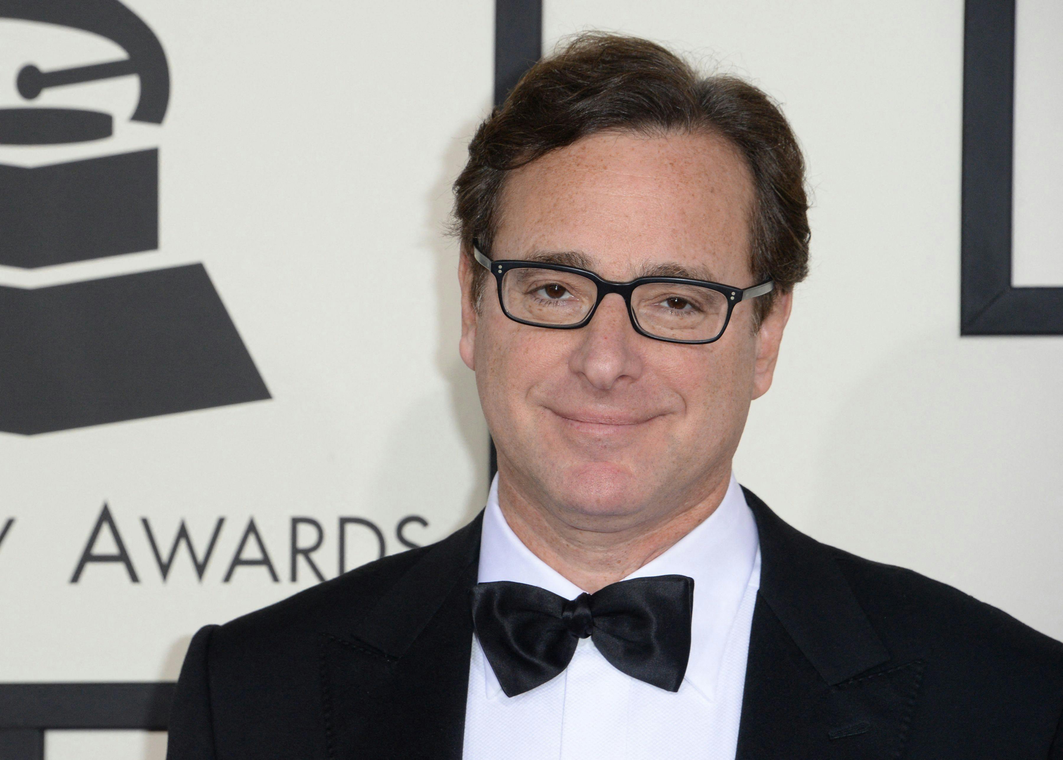 (FILES) In this file photo taken on January 26, 2014 Bob Saget arrives on the red carpet for the 56th Grammy Awards at the Staples Center in Los Angeles, California. - Bob Saget, the US comedian who delighted millions as the star of television's "Full House" in the 1980s and 1990s, has been found dead in a Florida hotel room, the local sheriff said on January 9, 2022. (Photo by Robyn BECK / AFP)