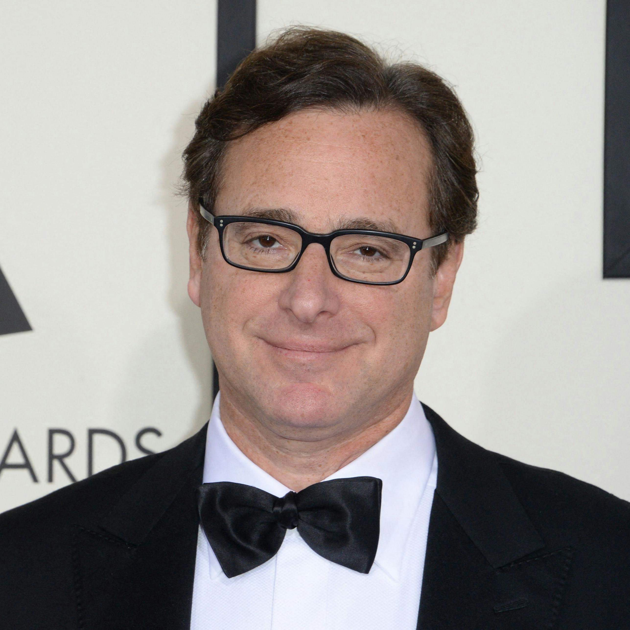 (FILES) In this file photo taken on January 26, 2014 Bob Saget arrives on the red carpet for the 56th Grammy Awards at the Staples Center in Los Angeles, California. - Bob Saget, the US comedian who delighted millions as the star of television's "Full House" in the 1980s and 1990s, has been found dead in a Florida hotel room, the local sheriff said on January 9, 2022. (Photo by Robyn BECK / AFP)