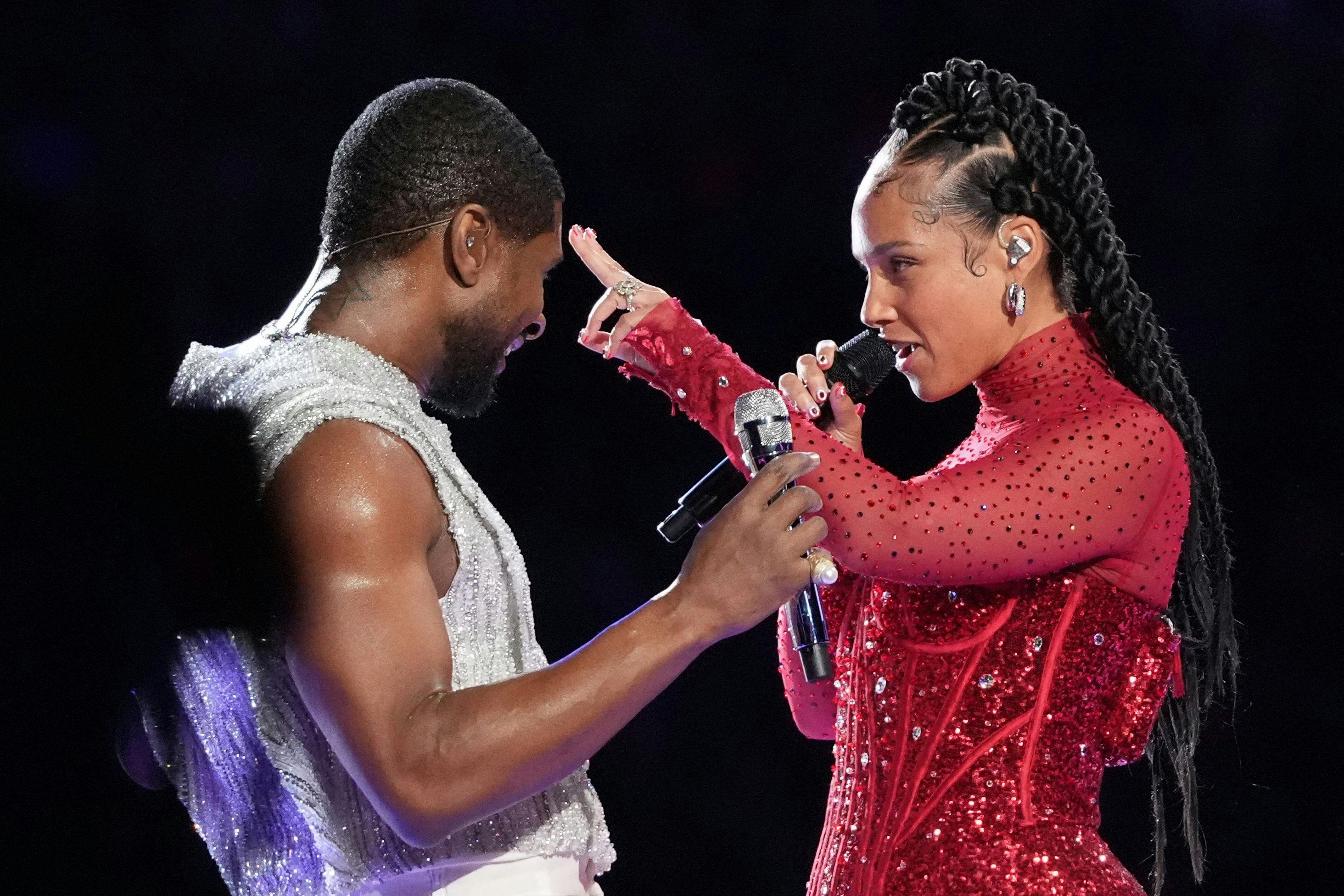 US singer-songwriter Usher performs with US singer-songwriter Alicia Keys (R) during Apple Music halftime show of Super Bowl LVIII between the Kansas City Chiefs and the San Francisco 49ers at Allegiant Stadium in Las Vegas, Nevada, February 11, 2024. (Photo by TIMOTHY A. CLARY / AFP)