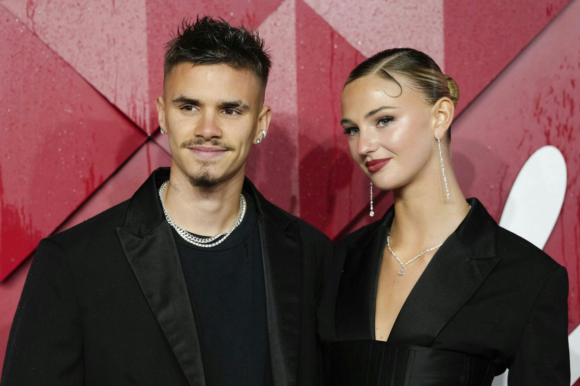 Romeo Beckham, left, and Mia Regan pose for photographers upon arrival at the British Fashion Awards on Monday, Dec. 4, 2023 in London. (Scott Garfitt/Invision/AP)