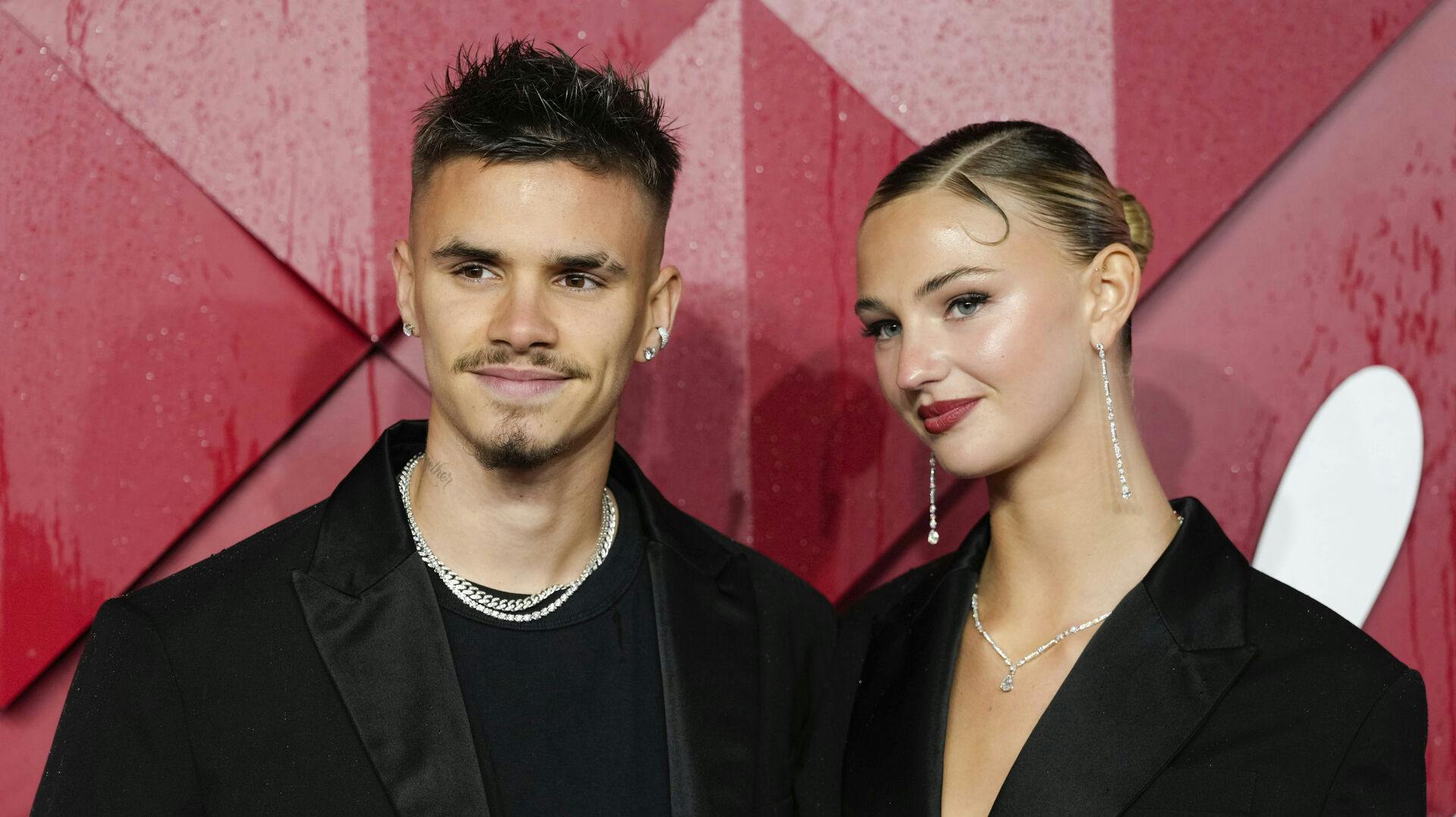 Romeo Beckham, left, and Mia Regan pose for photographers upon arrival at the British Fashion Awards on Monday, Dec. 4, 2023 in London. (Scott Garfitt/Invision/AP)