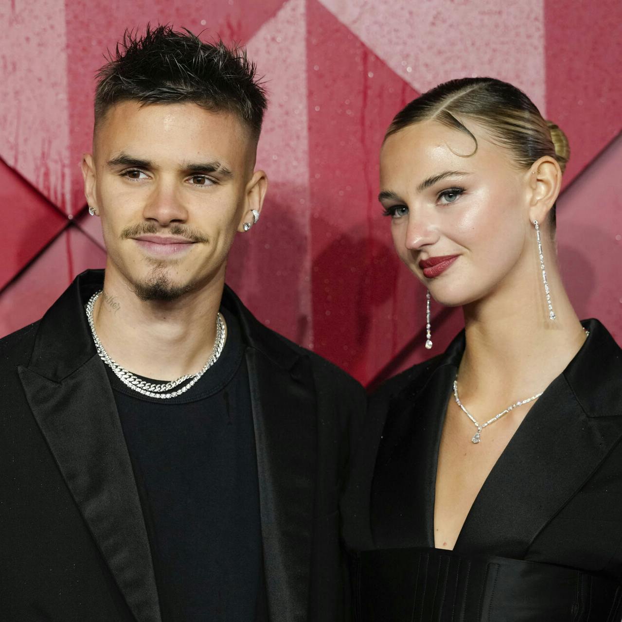 Romeo Beckham, left, and Mia Regan pose for photographers upon arrival at the British Fashion Awards on Monday, Dec. 4, 2023 in London. (Scott Garfitt/Invision/AP)