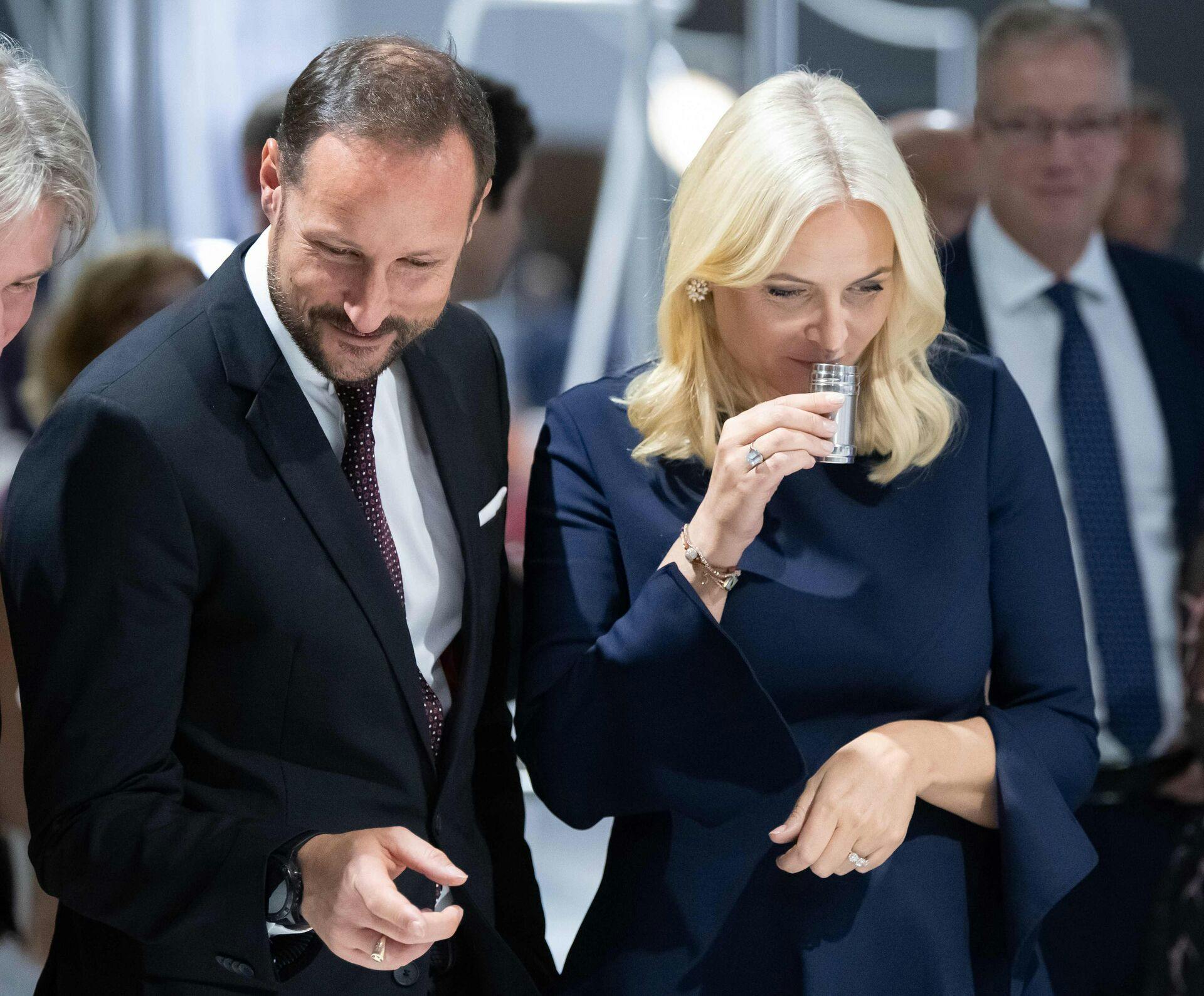 Crown Princess Mette-Marit of Norway trys an odour test while visiting an art installation with Crown Prince Haakon of Norway attend the opening of the Frankfurt Book Fair on October 15, 2019 in Frankfurt am Main, western Germany. - Norway is this year's honorary guest of the fair running from October 16 to 20, 2019. (Photo by Silas Stein / dpa / AFP) / Germany OUT