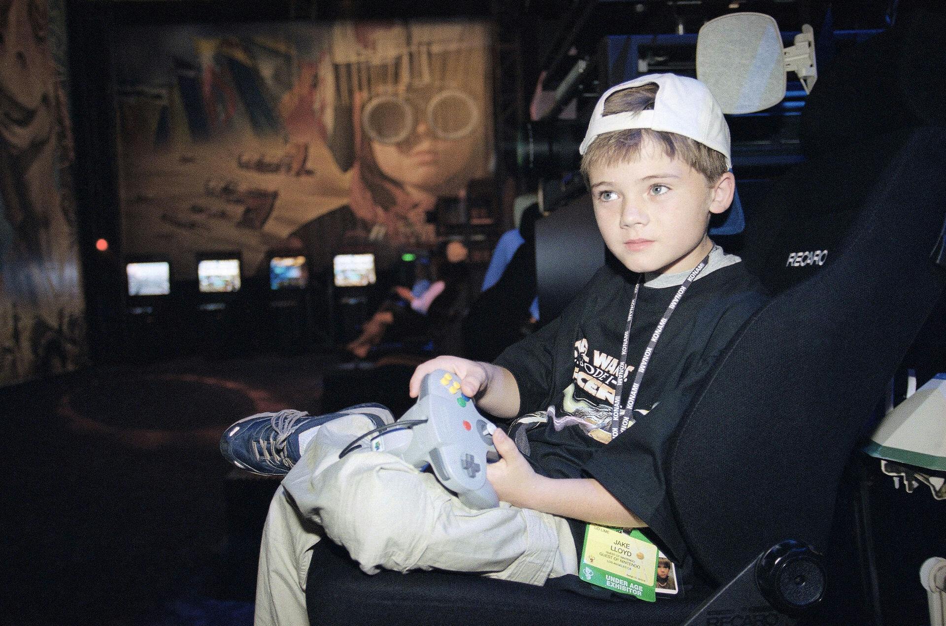 Actor Jake Lloyd; who portrays young Anakin Skywalker in the film Star Wars Episode I: The Phantom Menace; plays a new Nintendo game 'Star Wars Episode I Racer' at the Los Angeles Convention Center during the Electronic Entertainment Expo, Thursday, May 13, 1999, billed as the showcase for the global video and PC game industry. The E3 expo opened on Thursday. (AP Photo/Kevork Djansezian)
