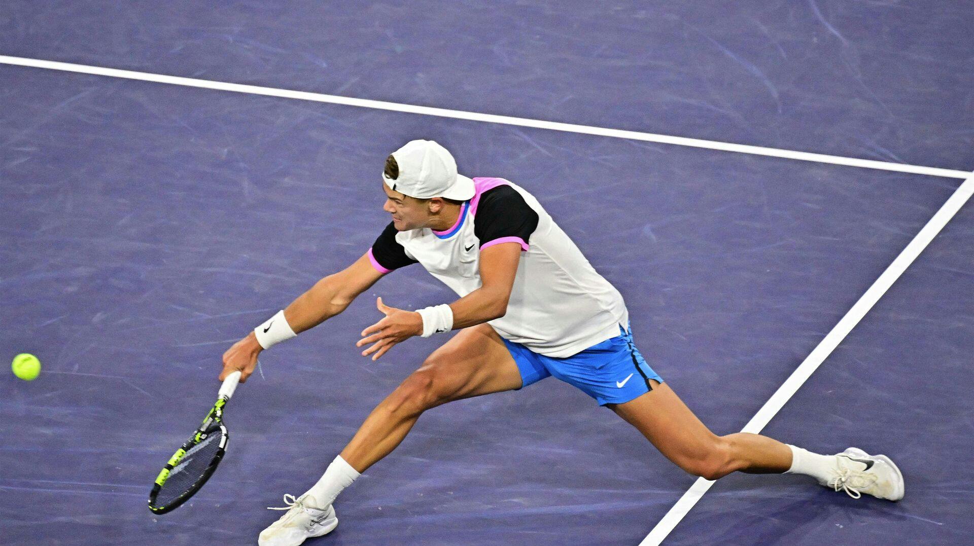 Denmark's Holger Rune plays a backhand return