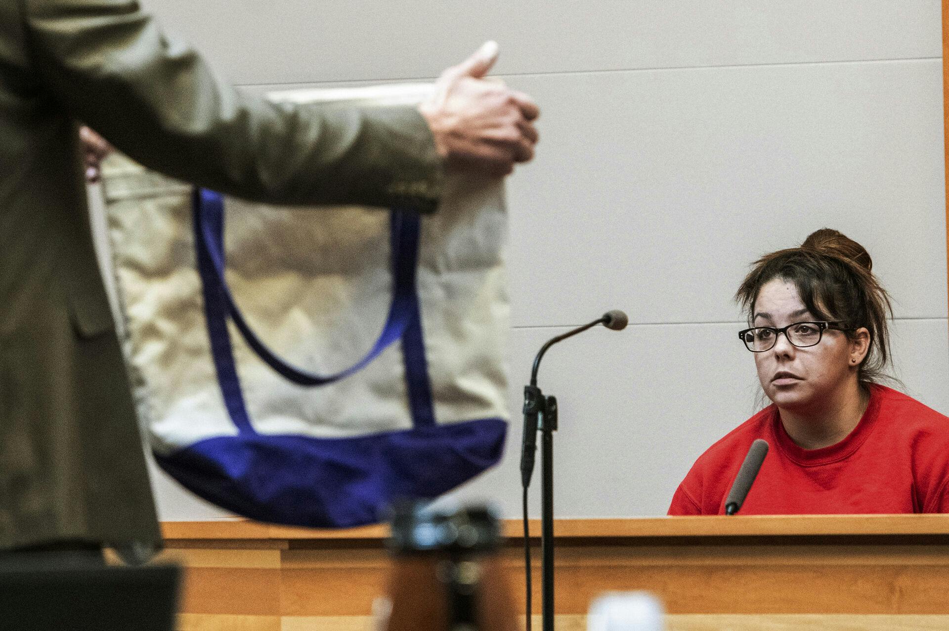 Kayla Montgomery is shown a tote bag while testifying during the trial of Adam Montgomery at Hillsborough County Superior Court, Monday Feb. 12, 2024, in Manchester, N.H. Adam Montgomery is accused of killing his 5-year-old daughter and spending months moving her body before disposing of it. (Jeffrey Hastings/Pool Photo via AP)