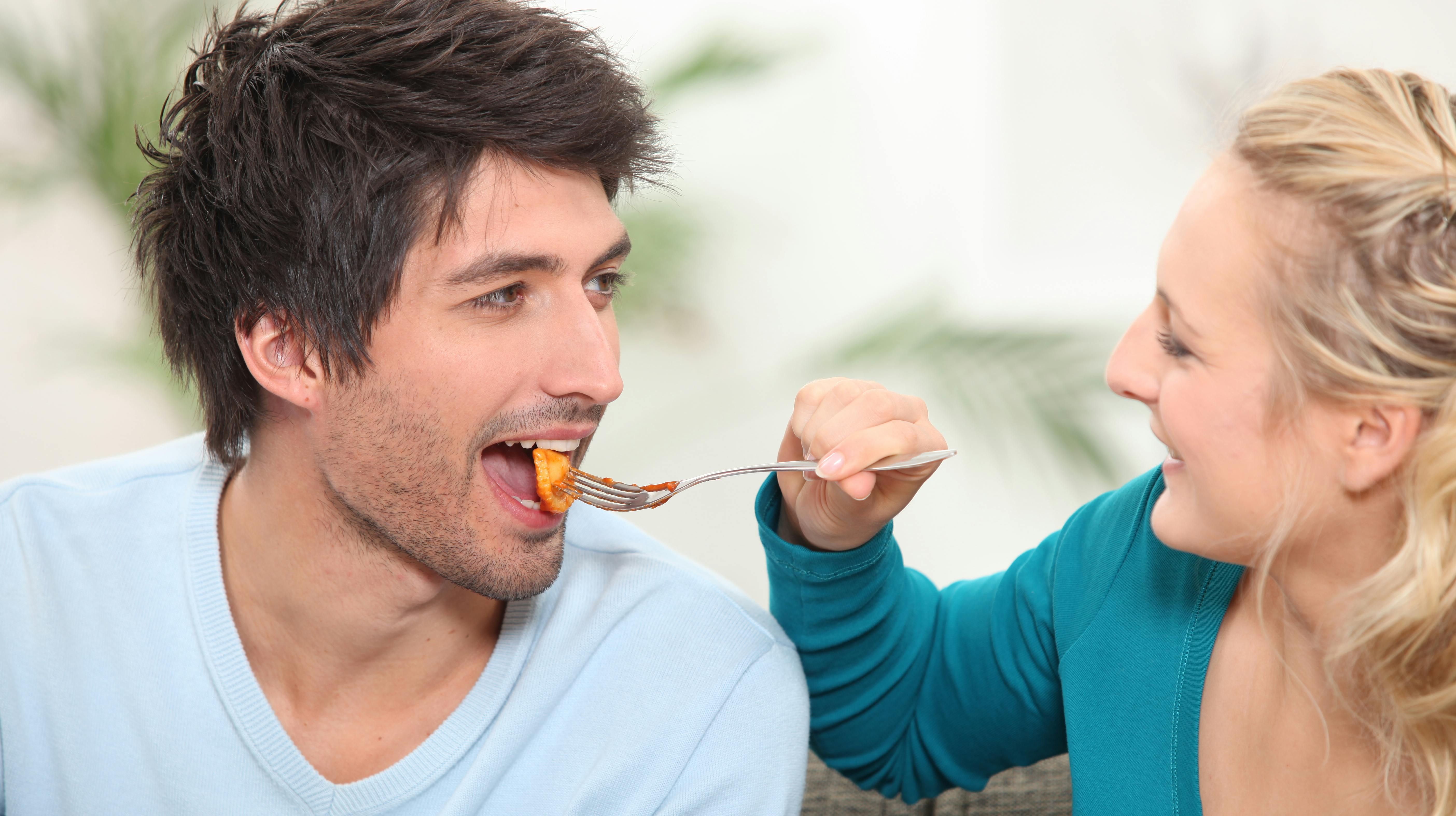 Woman feeding her husband food