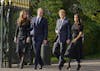 FILE - Britain's Prince William, second left, Kate, Princess of Wales, left, Britain's Prince Harry, second right, and Meghan, Duchess of Sussex view the floral tributes for the late Queen Elizabeth II outside Windsor Castle, in Windsor, England on Sept. 10, 2022. (AP Photo/Martin Meissner, File)