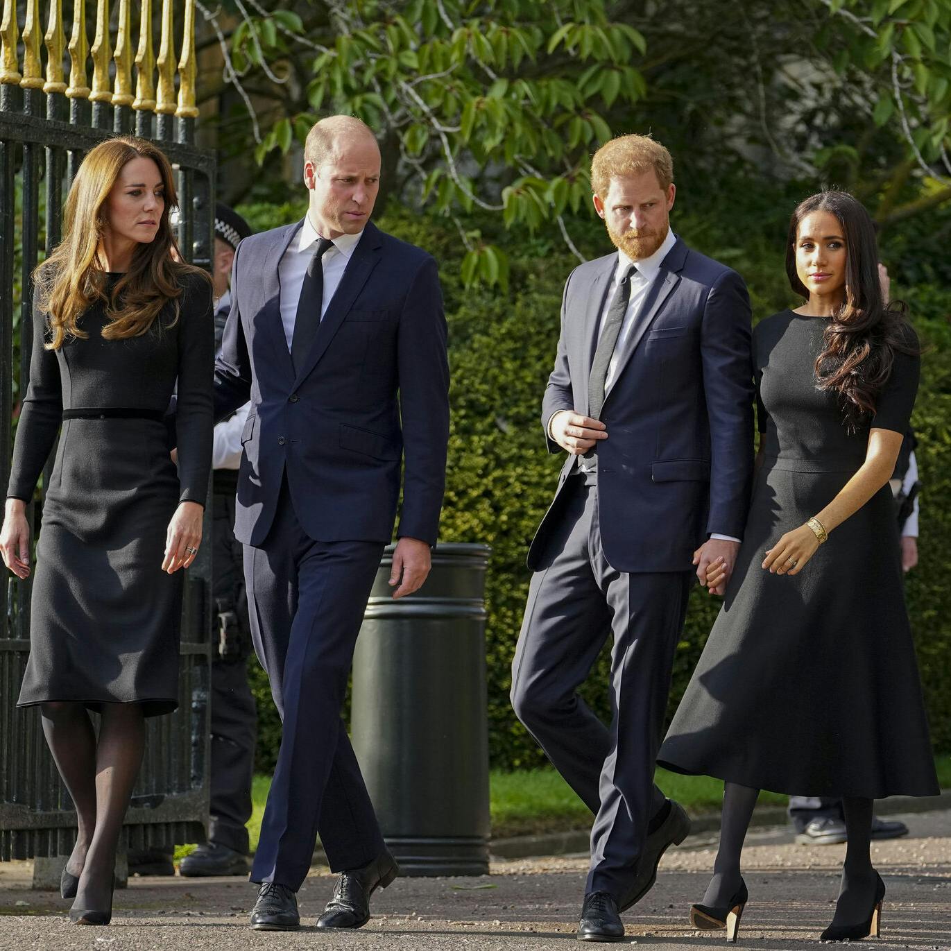 FILE - Britain's Prince William, second left, Kate, Princess of Wales, left, Britain's Prince Harry, second right, and Meghan, Duchess of Sussex view the floral tributes for the late Queen Elizabeth II outside Windsor Castle, in Windsor, England on Sept. 10, 2022. (AP Photo/Martin Meissner, File)