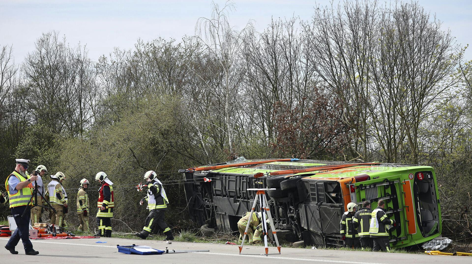 A coach lies overturned on its side at the scene of an accident on the A9, near Schkeuditz, Germany, Wednesday March 27. 2024. (Jan Woitas/dpa via AP)
