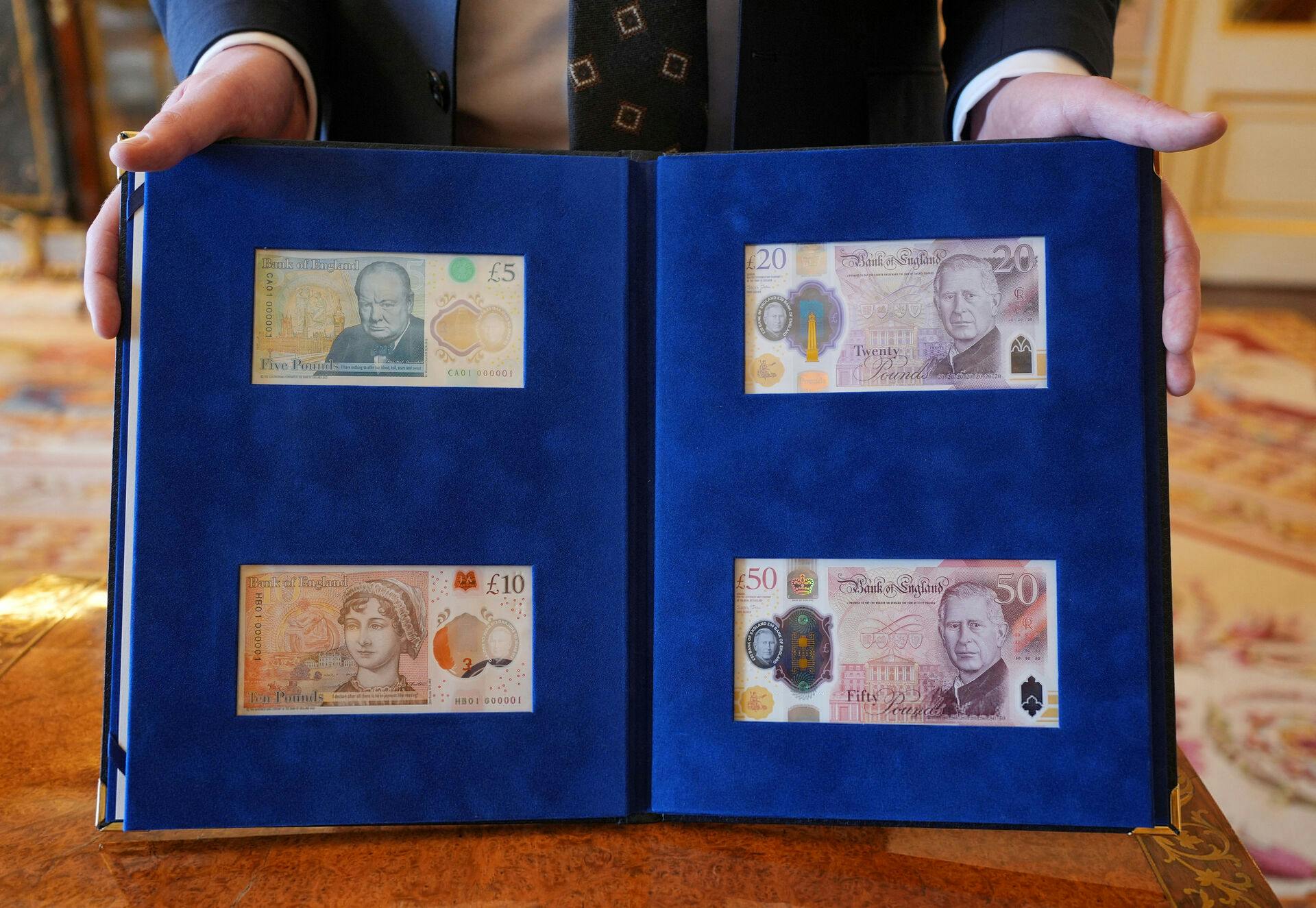 New banknotes bearing a portrait of King Charles, Winston Churchill, and Jane Austen are presented to the King by the Bank of England Governor Andrew Bailey, at Buckingham Palace, London, Britain April 9, 2024. Yui Mok/Pool via REUTERS