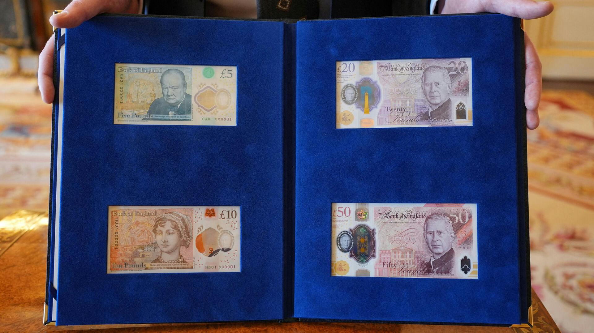 New banknotes bearing a portrait of King Charles, Winston Churchill, and Jane Austen are presented to the King by the Bank of England Governor Andrew Bailey, at Buckingham Palace, London, Britain April 9, 2024. Yui Mok/Pool via REUTERS