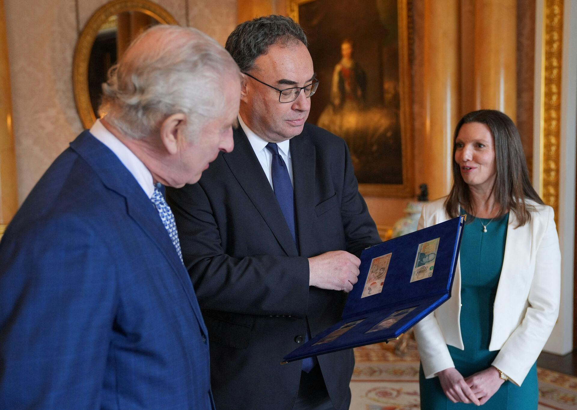 King Charles is presented with the first bank notes featuring his portrait from the Bank of England Governor Andrew Bailey and Sarah John, the Bank of England's Chief Cashier, at Buckingham Palace, London, Britain April 9, 2024. Yui Mok/Pool via REUTERS