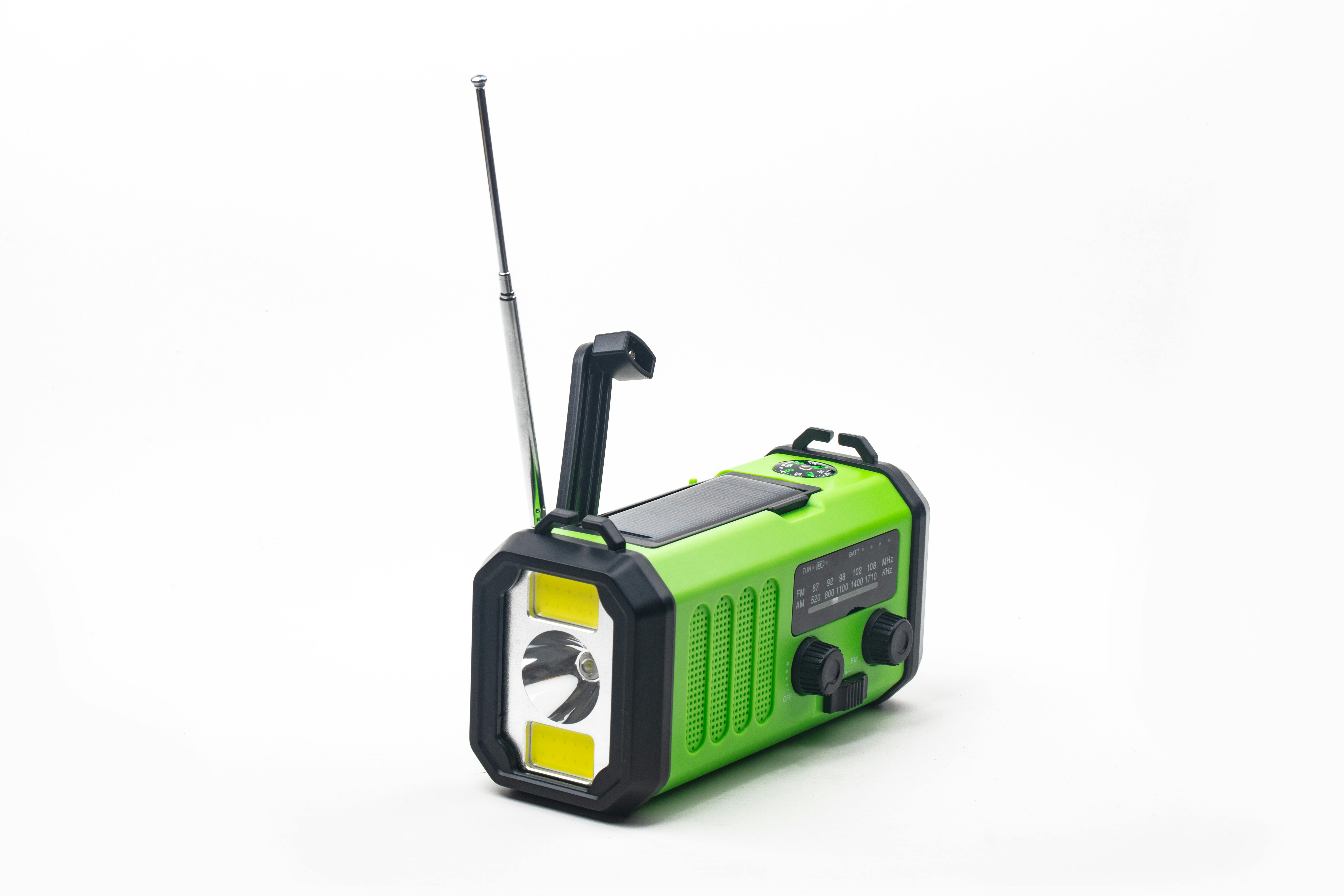 Emergency radio with flashlight rechargeable using built-in hand crank or solar cell
