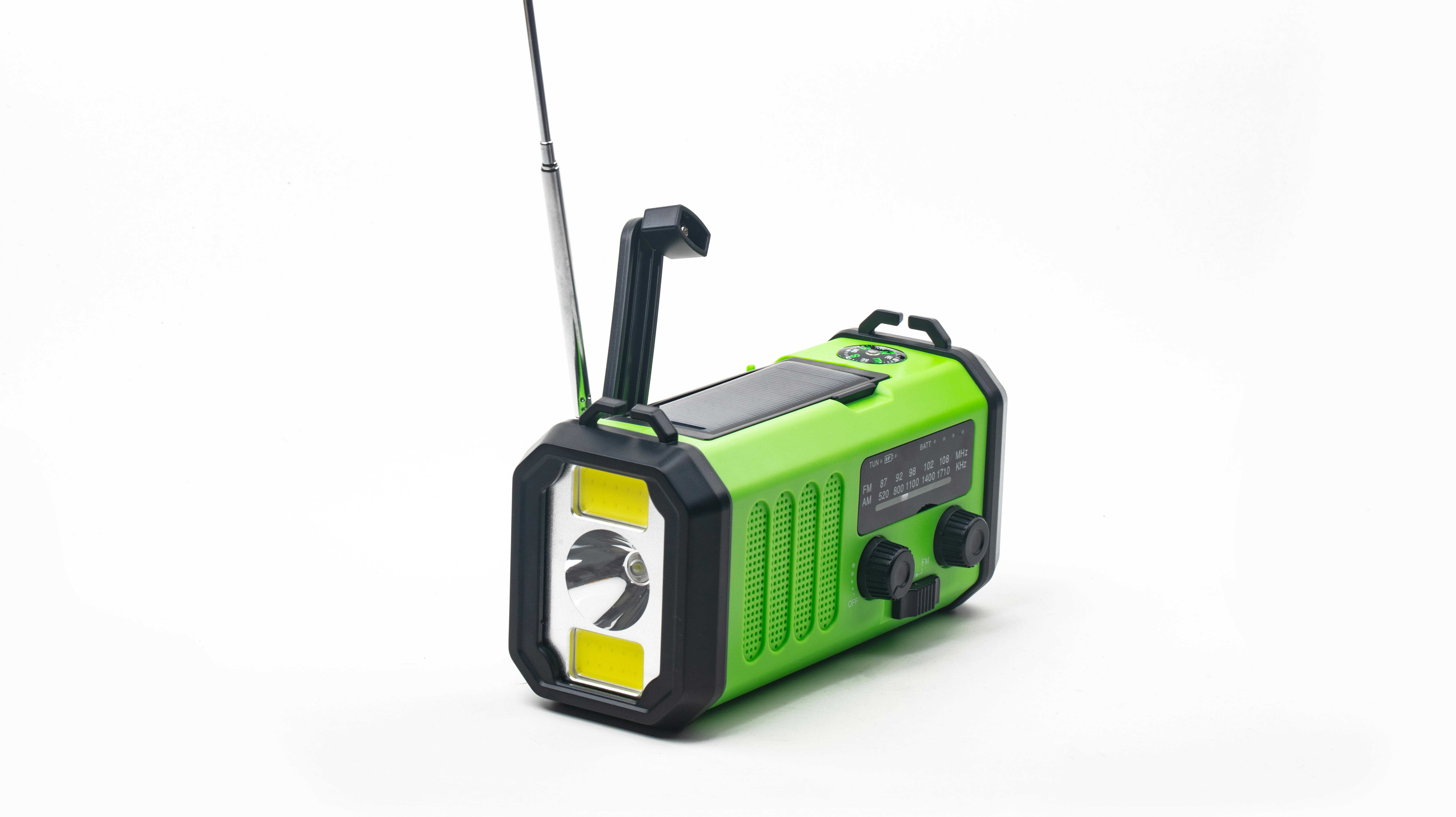 Emergency radio with flashlight rechargeable using built-in hand crank or solar cell