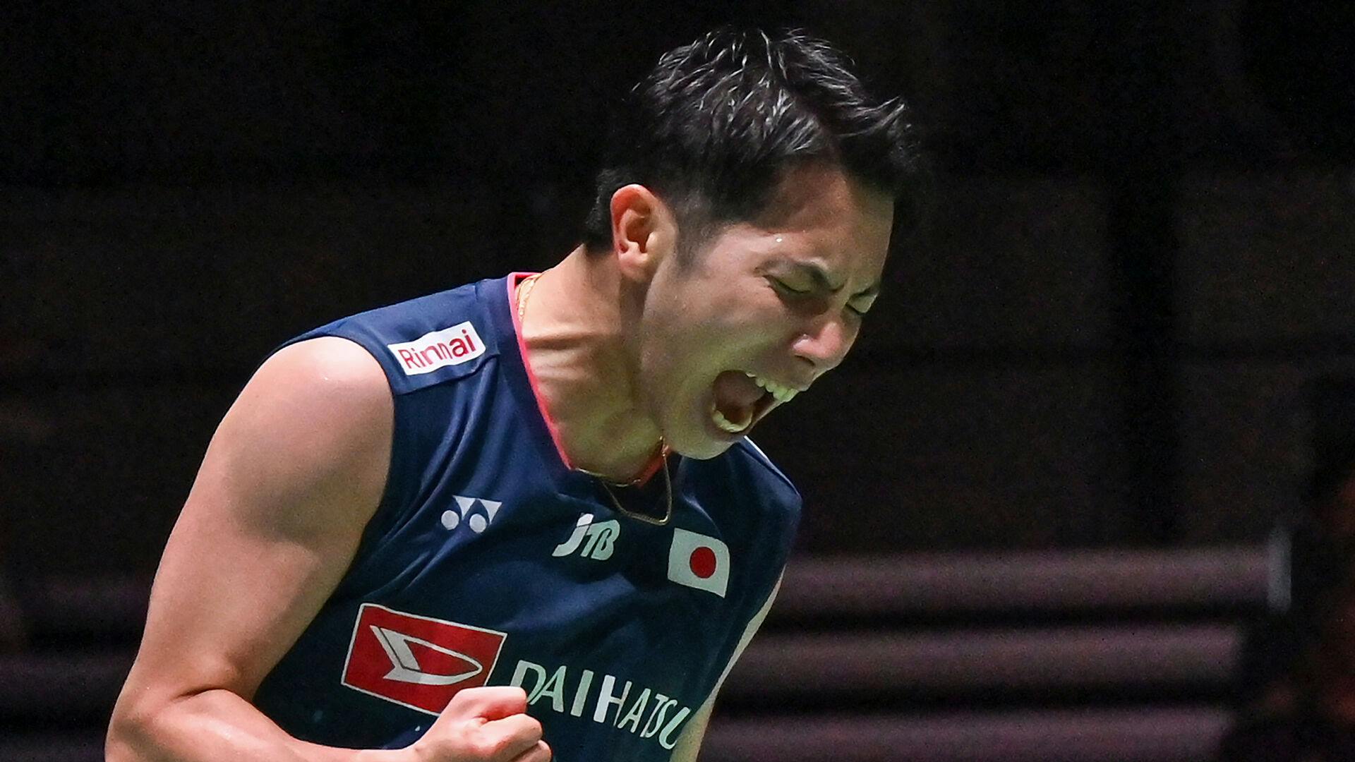 Koki Watanabe of Japan celebrates winning match point against Kento Momota of Japan during their men's singles match on the second day of the Japan Open badminton tournament in Tokyo on July 26, 2023. Richard A. Brooks / AFP