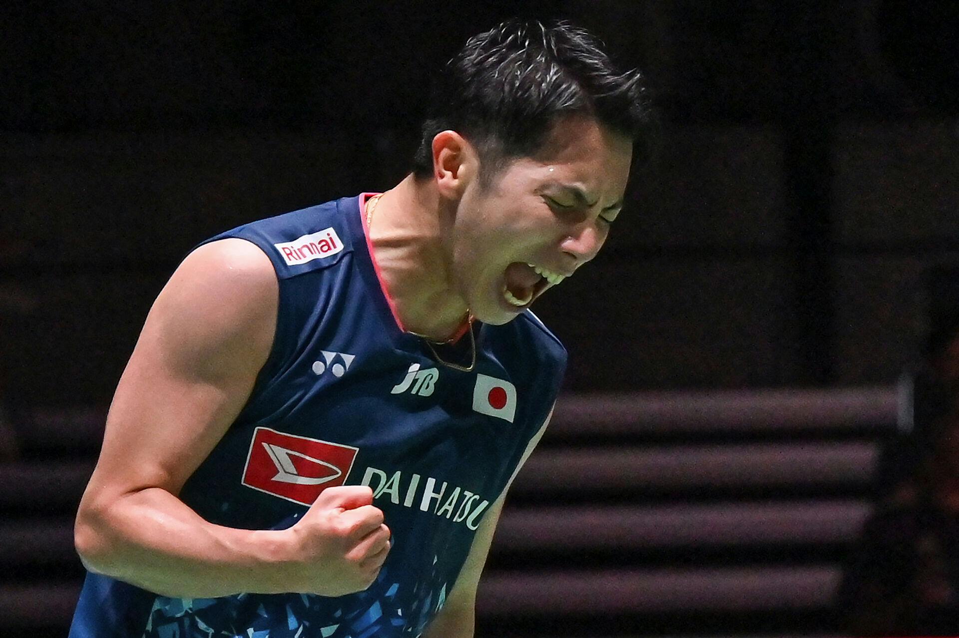 Koki Watanabe of Japan celebrates winning match point against Kento Momota of Japan during their men's singles match on the second day of the Japan Open badminton tournament in Tokyo on July 26, 2023. Richard A. Brooks / AFP