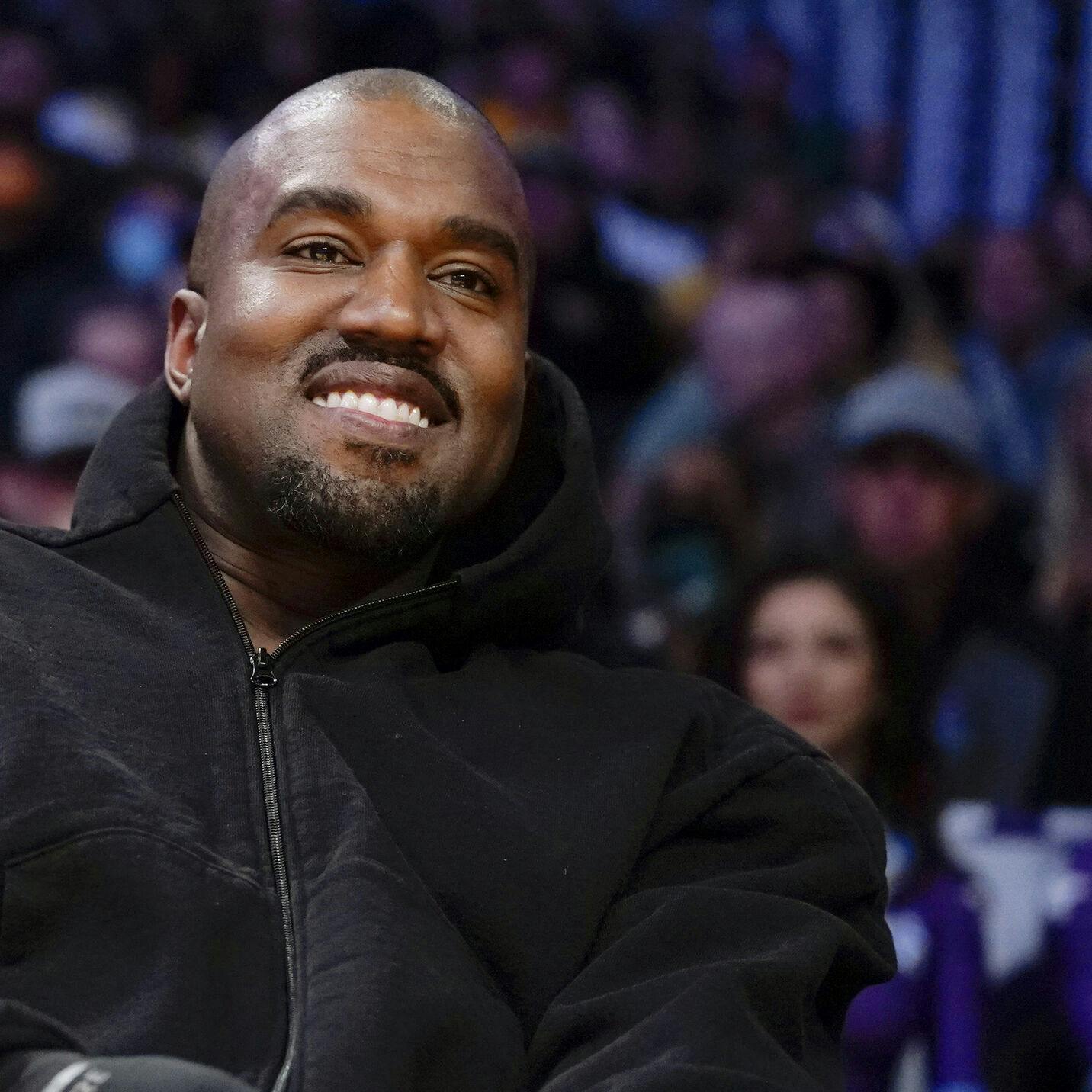 FILE - Kanye West, known as Ye, watches the first half of an NBA basketball game between the Washington Wizards and the Los Angeles Lakers, on March 11, 2022, in Los Angeles. Adidas said Wednesday March 13, 2024 that it's donated or is planning to give away more than $150 million to groups fighting antisemitism and other forms of hate from the sales of Yeezy shoes last year after it severed ties with Ye, the rapper formerly known as Kanye West. (AP Photo/Ashley Landis, File)
