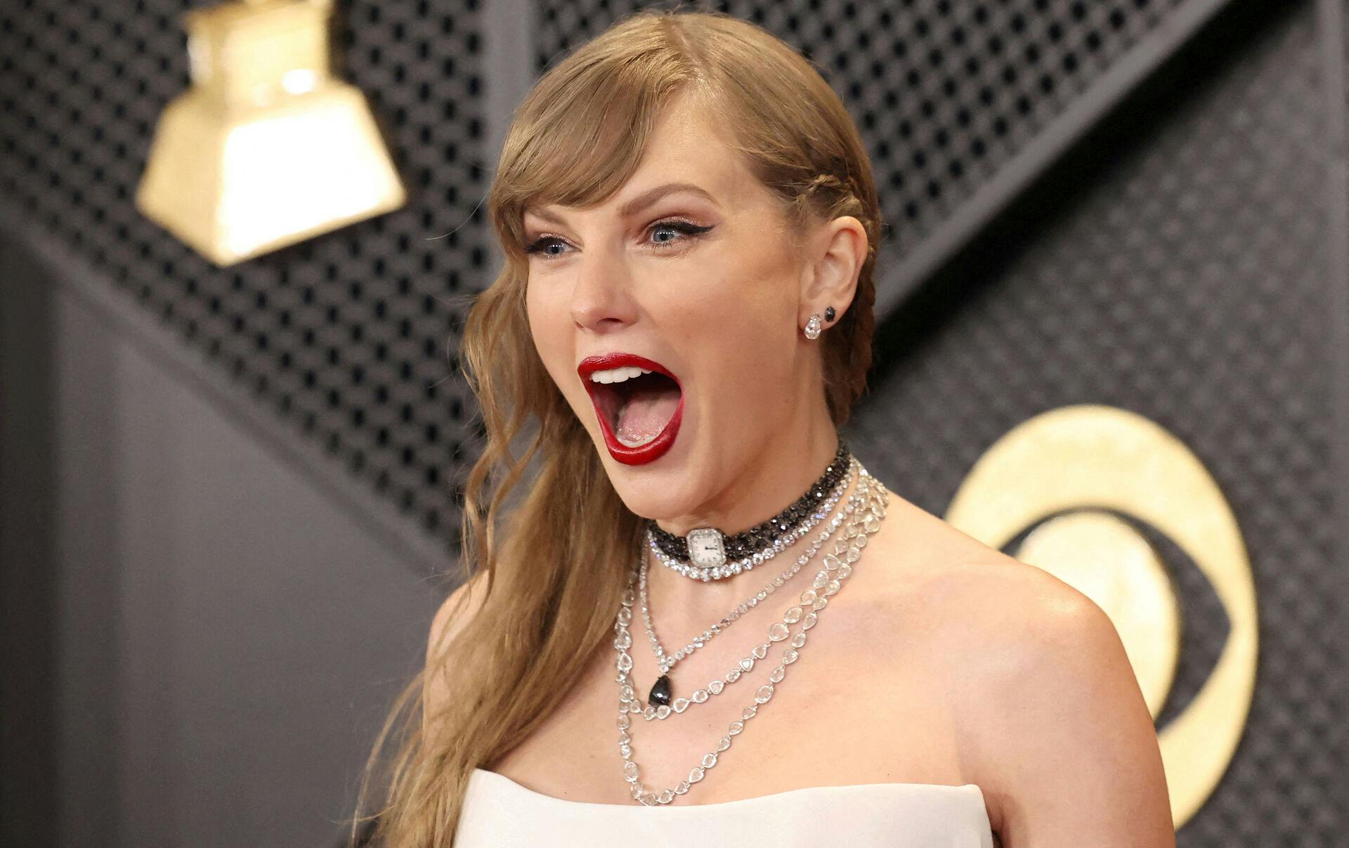 FILE PHOTO: Taylor Swift poses on the red carpet as she attends the 66th Annual Grammy Awards in Los Angeles, California, U.S., February 4, 2024. REUTERS/Mario Anzuoni/File Photo