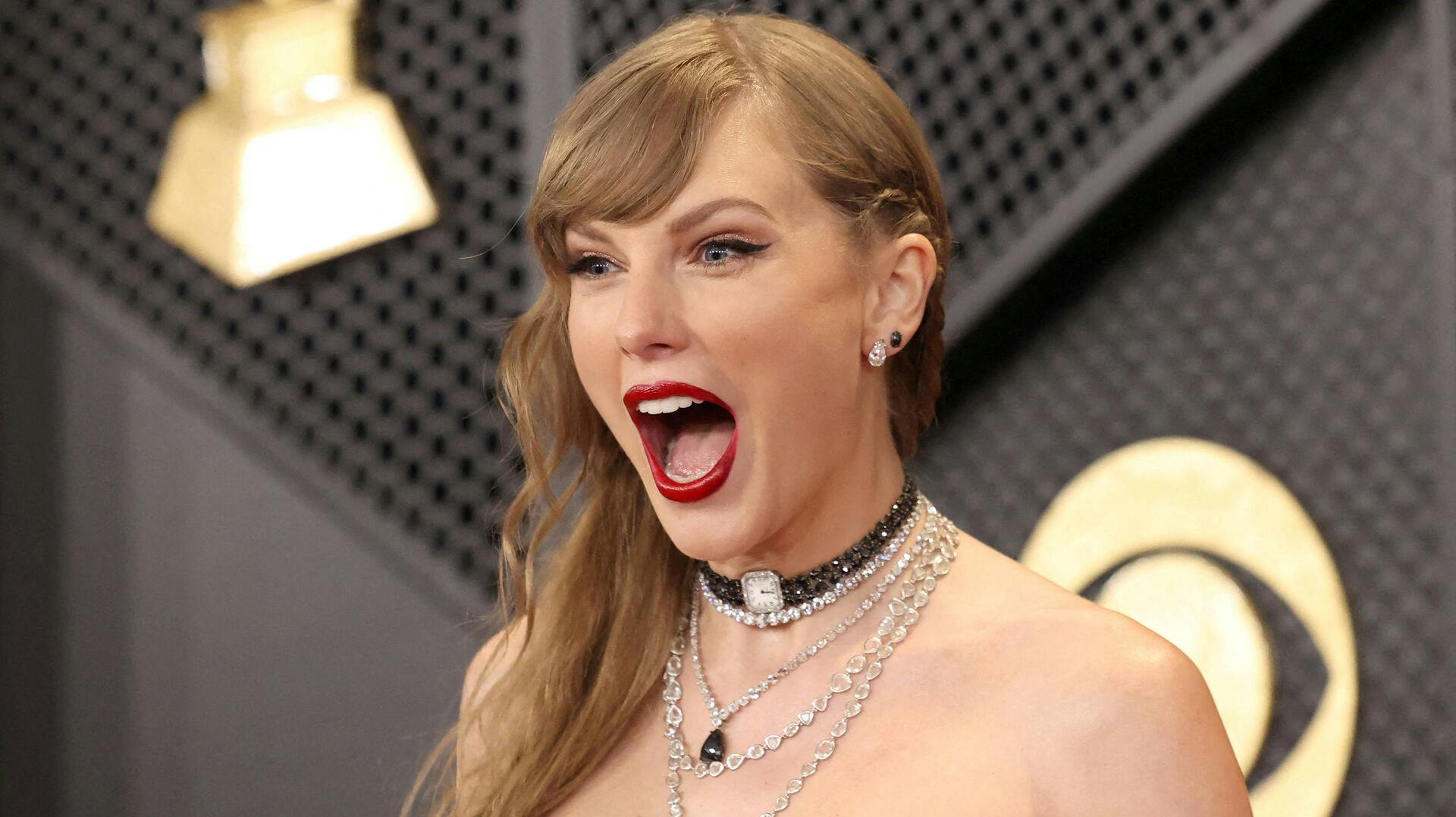 FILE PHOTO: Taylor Swift poses on the red carpet as she attends the 66th Annual Grammy Awards in Los Angeles, California, U.S., February 4, 2024. REUTERS/Mario Anzuoni/File Photo