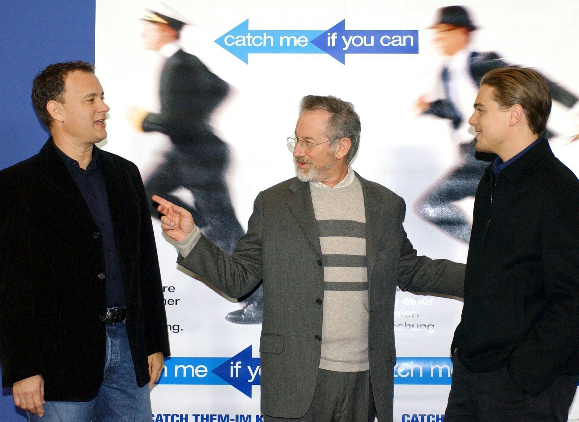 (dpa) - US actors Tom Hanks (L) and Leonardo DiCaprio (R) as well as US film director Steven Spielberg pose in front of a movie poster ahead of the German premiere of their new film 'Catch Me If You Can' in Berlin, 26 January 2003. The film, based on a true story, is about a successful con artist (DiCaprio) who manages to pass himself off as several identities while chased by the FBI agent played by Tom Hanks. Photo by: Stephanie Pilick/picture-alliance/dpa/AP Images